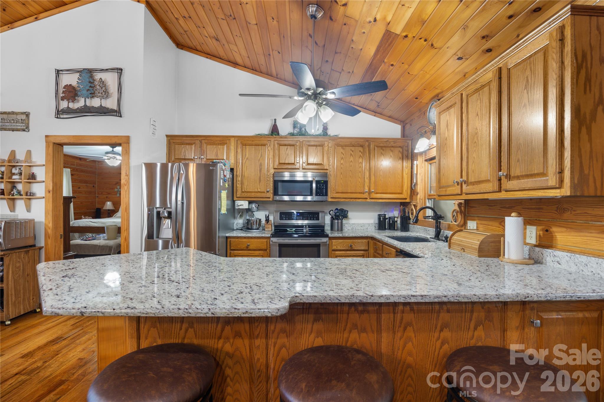 Granite countertops and a convenient eat-in bar for casual dining. - 214 Harbor Ridge Drive, Connelly Springs