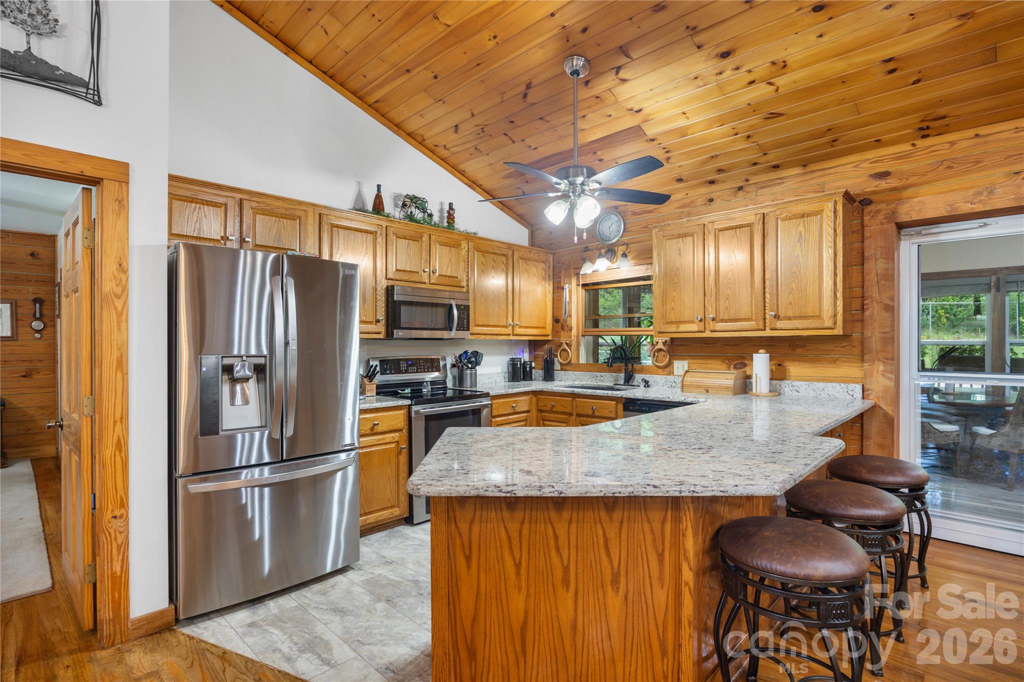 Large kitchen features granite counters, stainless appliances, and storage galore. - 214 Harbor Ridge Drive, Connelly Springs