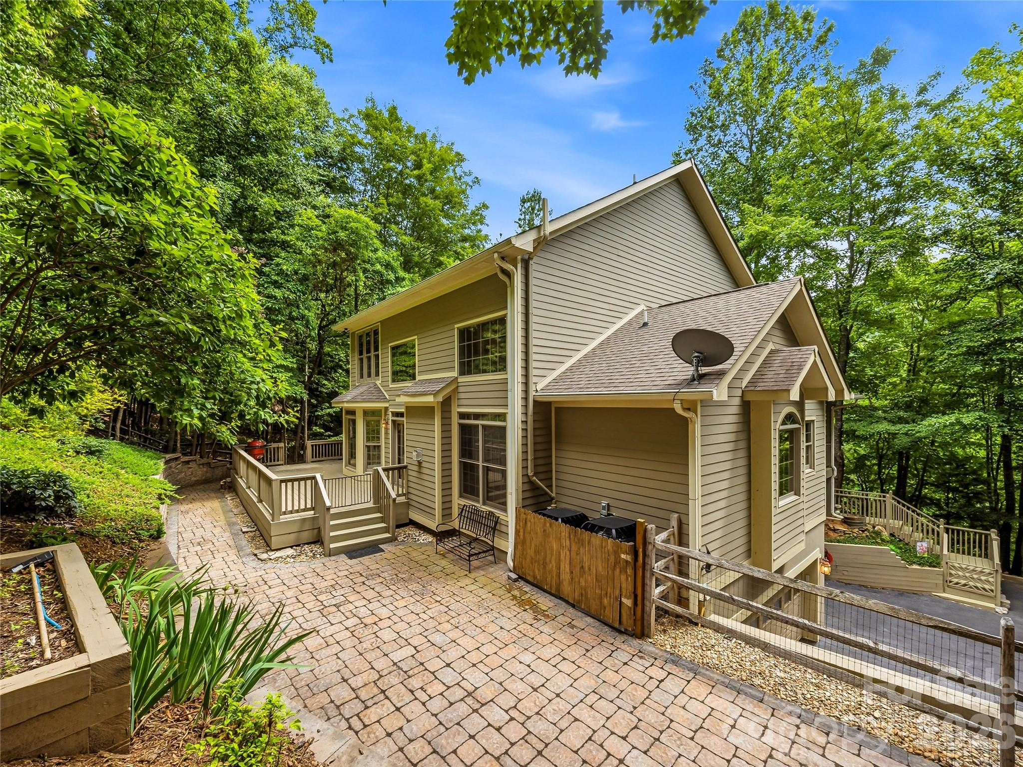 A view of the house from the rear of the property. The house gets a lot of light. - 840 Stoney Stream Lane, Arden