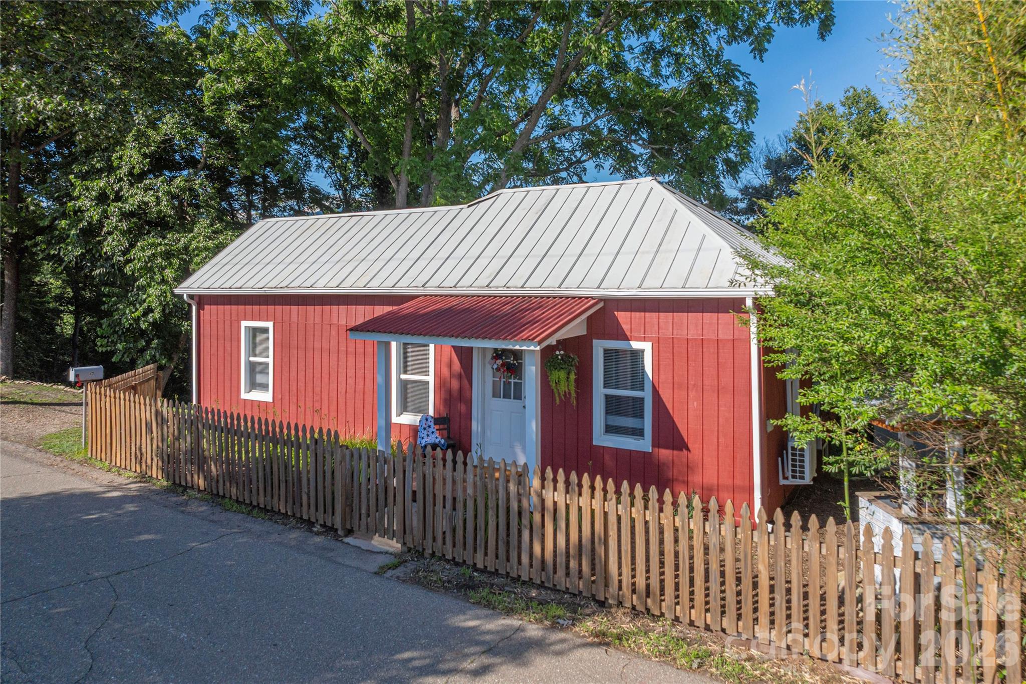 Charming cottage exterior featuring a covered front porch, metal roof, and mountain views. - 261 Star Ridge Road, Canton