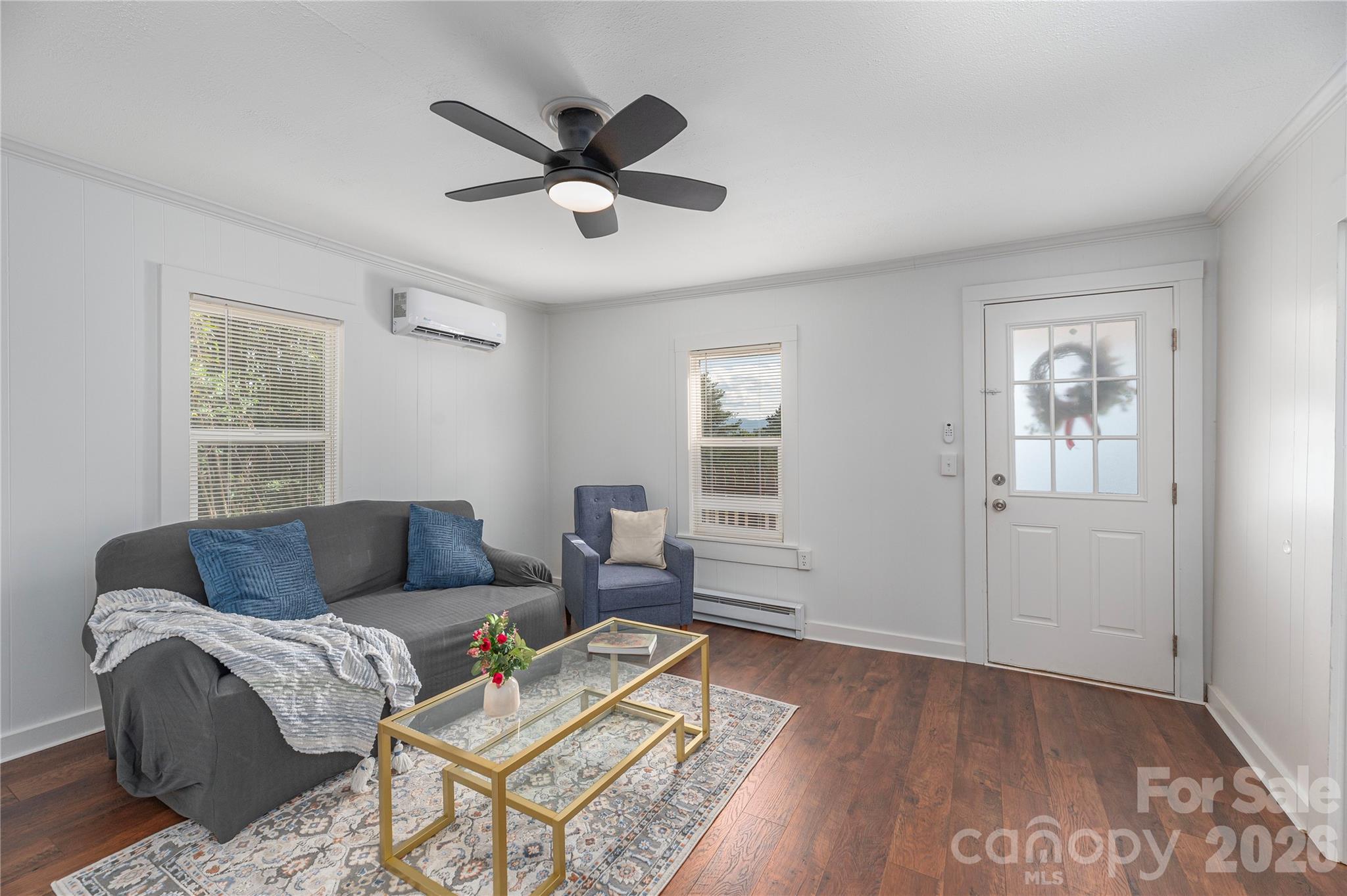Light-filled living room with updated flooring and comfortable gathering space. - 261 Star Ridge Road, Canton