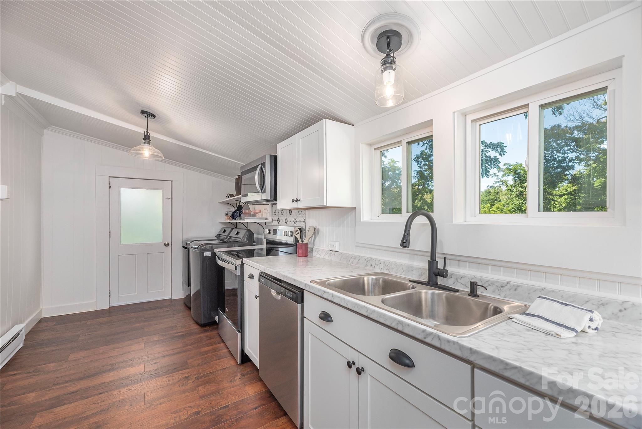 Kitchen features generous counter space, updated cabinetry, and backyard views. - 261 Star Ridge Road, Canton