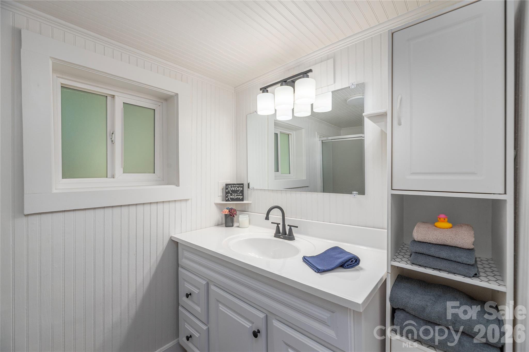 Updated bathroom featuring a modern vanity, fixtures, and beadboard accents. - 261 Star Ridge Road, Canton