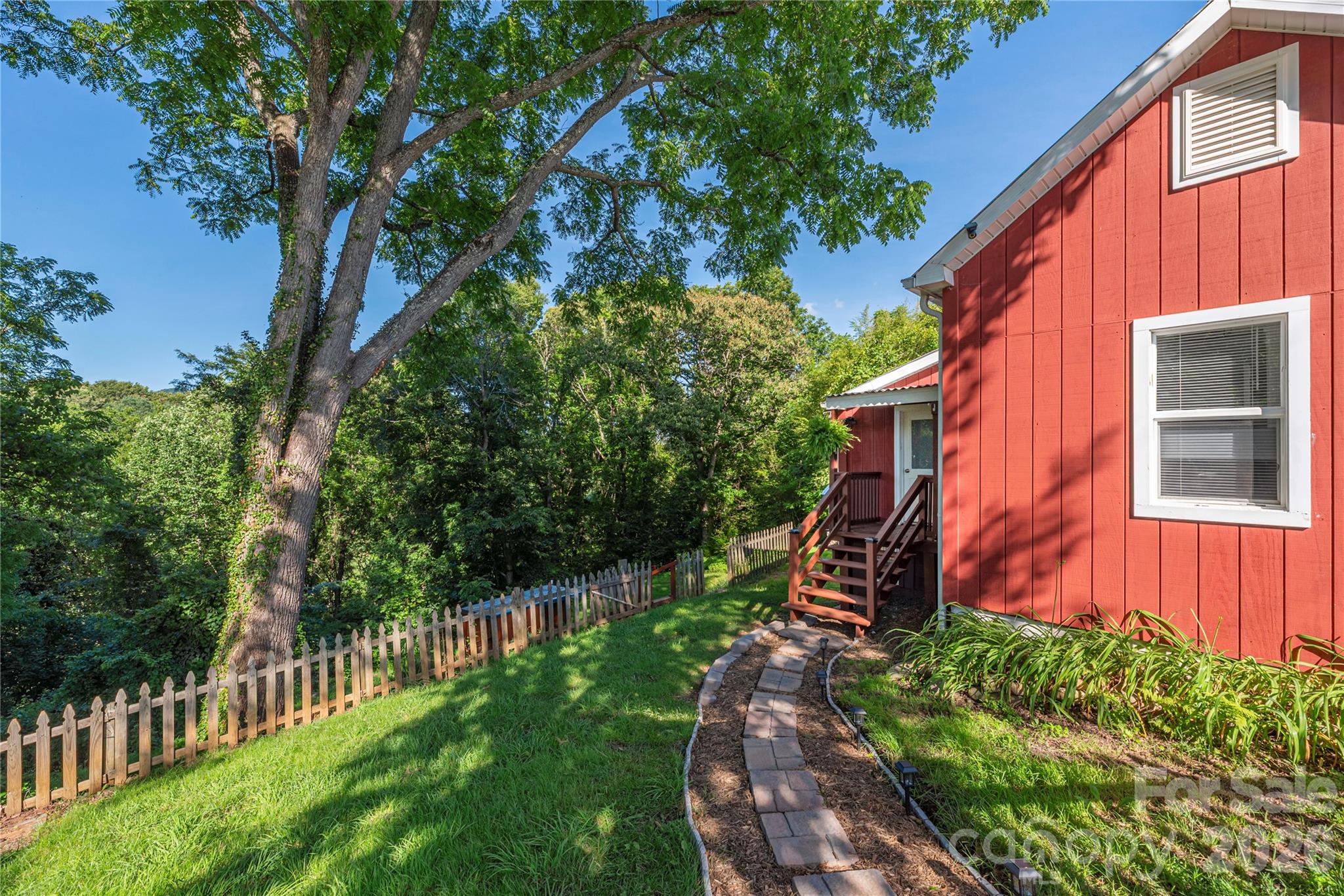 New stone walkway leads to the side entrance, surrounded by mature landscaping. - 261 Star Ridge Road, Canton