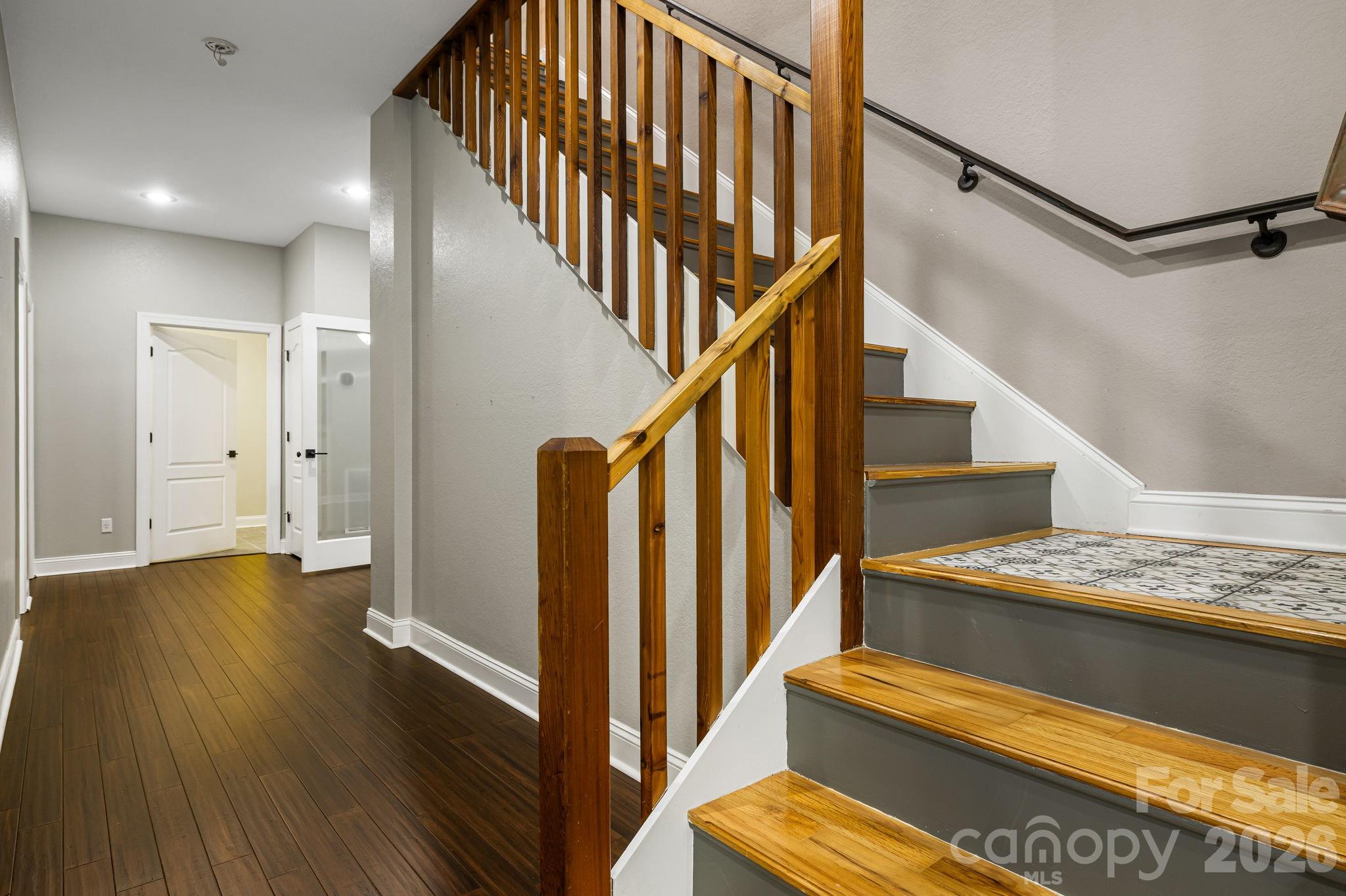 Downstairs stair landing with custom tile - 67 Reeses Ridge Court, Hendersonville