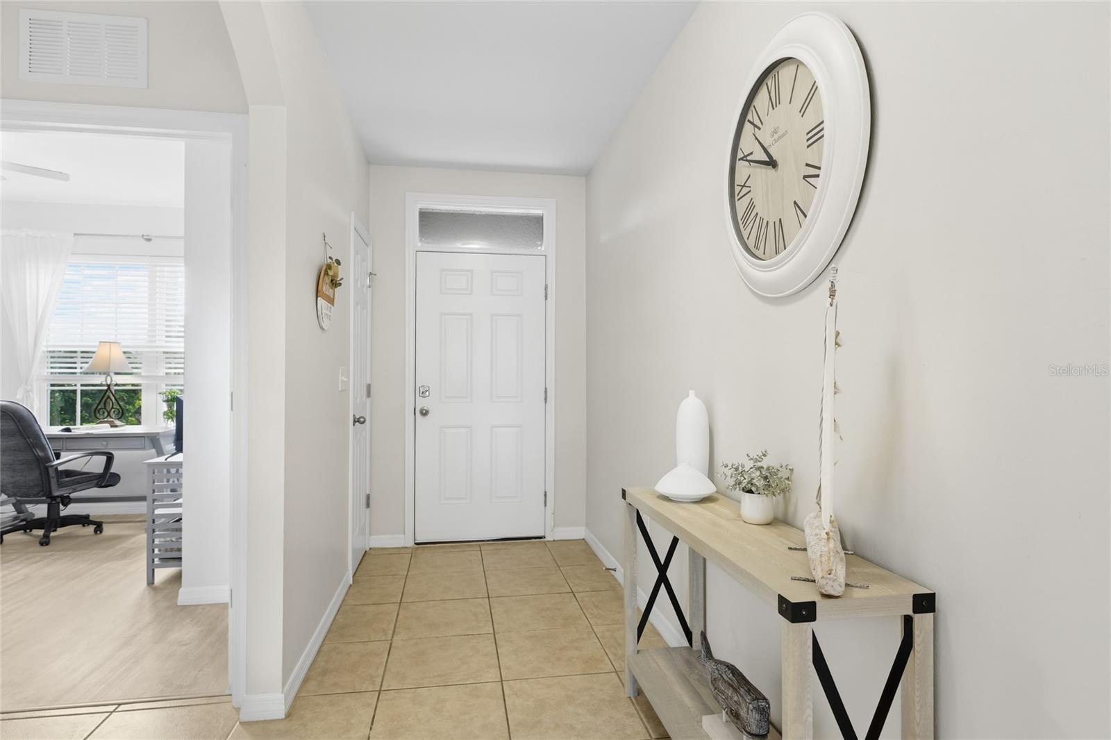 Beautiful long and wide foyer and hallway to an open concept living area - 24413 BANDONI PL, VENICE