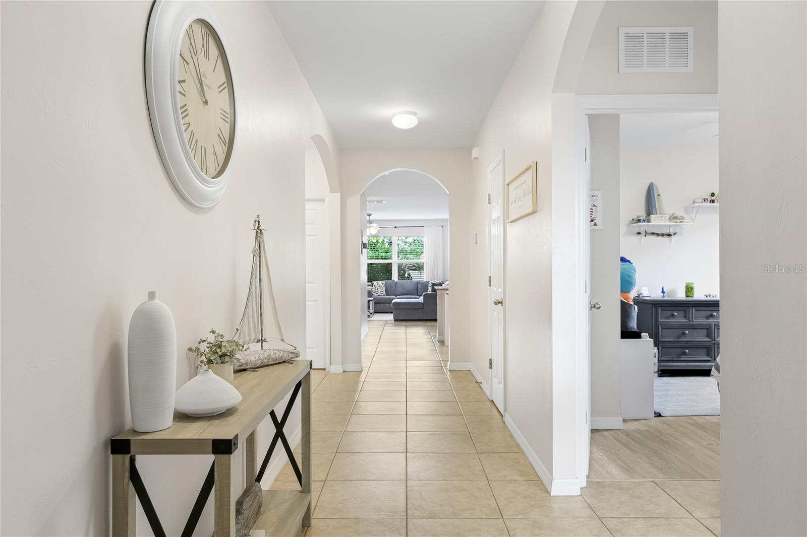 Beautiful long and wide foyer and hallway to an open concept living area - 24413 BANDONI PL, VENICE
