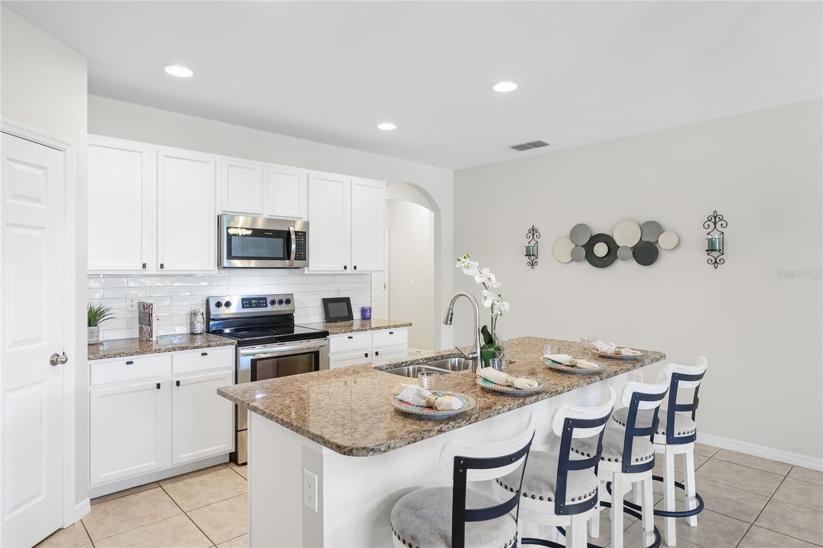 Large Kitchen with Grande Island and abundant seating space for functional living and entertaining. - 24413 BANDONI PL, VENICE
