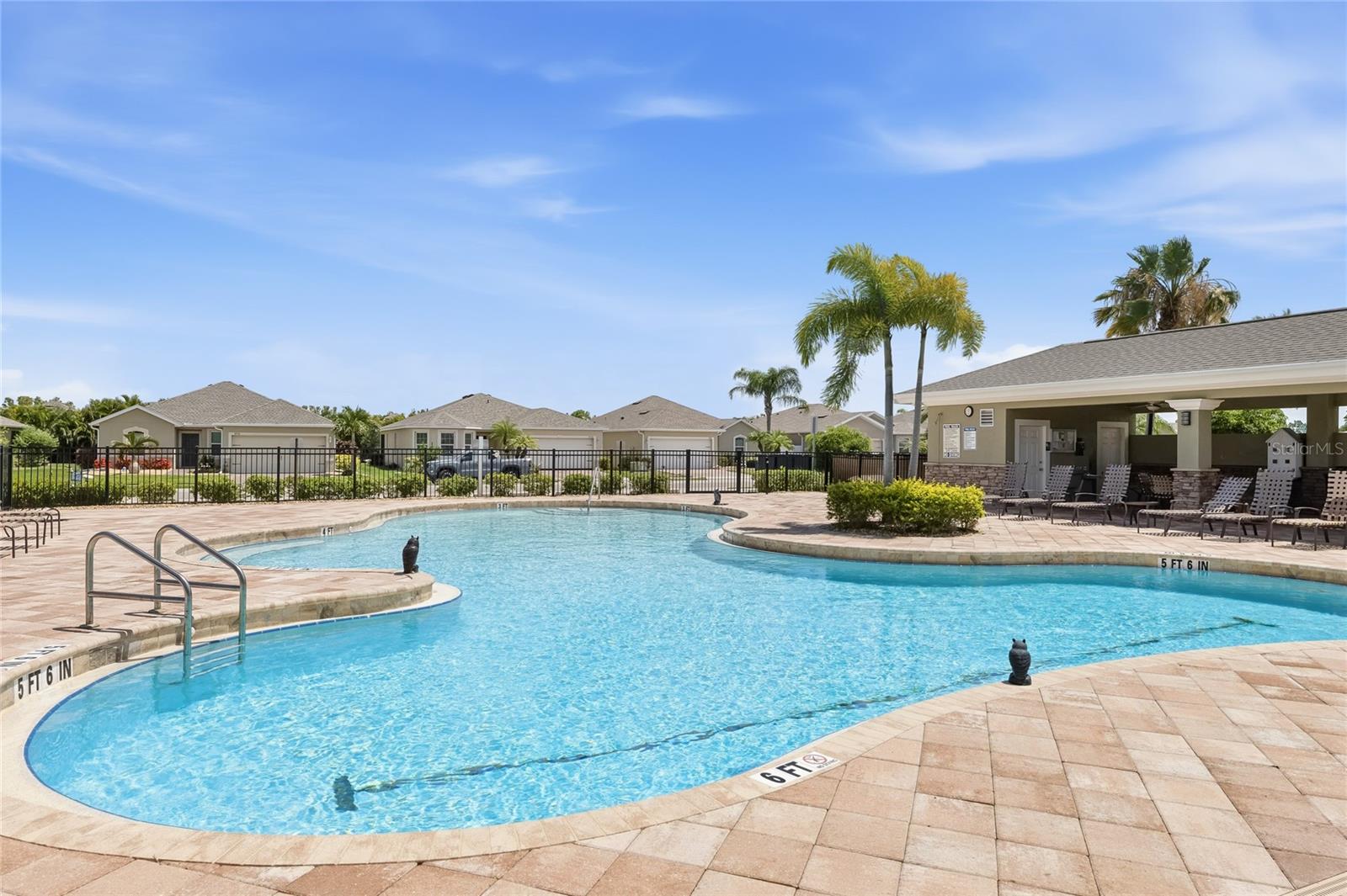 Large Community Pool with lounge chairs for sunbathing. Covered Pavilion with outdoor tables and chairs to enjoy lunch, dinner or a snack while getting out of the sun. Restrooms available as well. - 24413 BANDONI PL, VENICE