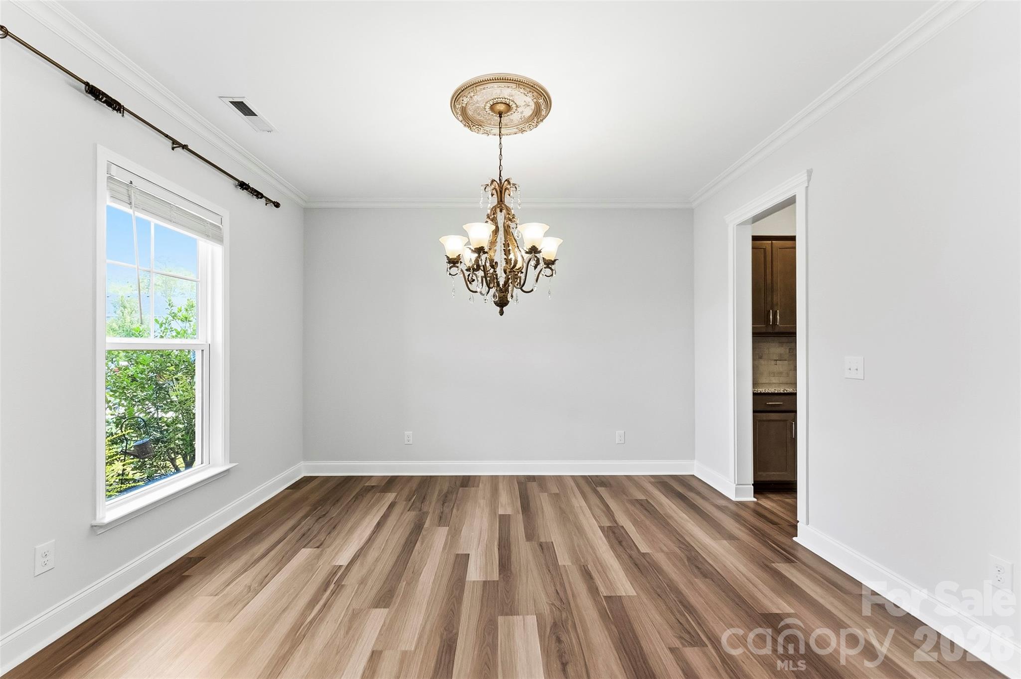 Formal Dining Room with upgraded lighting, beautiful flooring and freshly painted. - 1318 Poppy Way, Matthews
