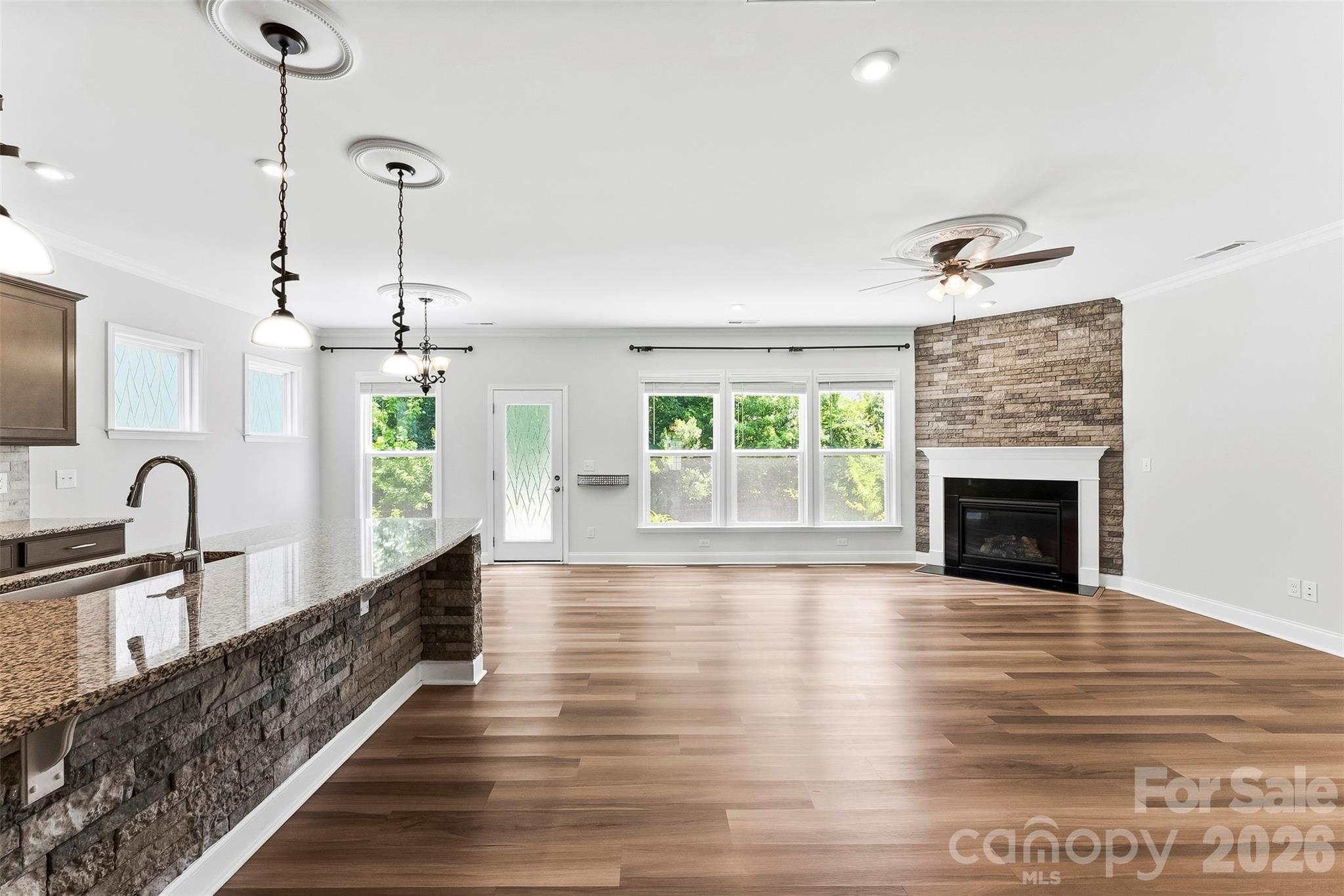 This Spacious Great Room is freshly painted. Gorgeous Flooring, Upgraded Lighting. Gas Fireplace. Wall of Windows for lots of natural lighting. Open Concept Floor Plan - 1318 Poppy Way, Matthews