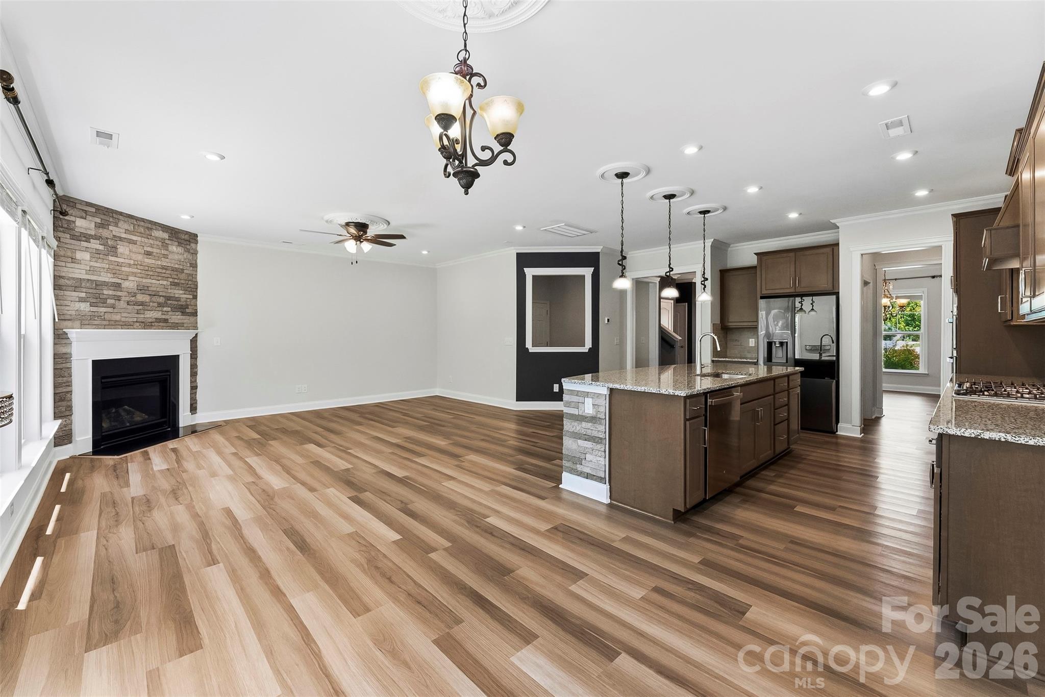 View from the Breakfast Room into the Kitchen and Great Room. Gorgeous Flooring, Freshly painted, upgraded lighting. - 1318 Poppy Way, Matthews