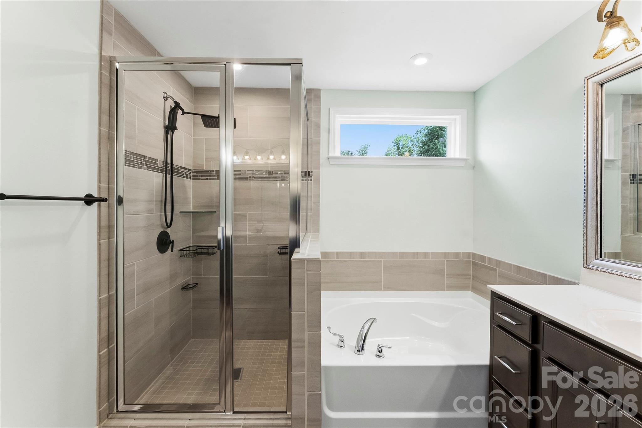 Beautiful tile work in the shower. Rain shower head - 1318 Poppy Way, Matthews