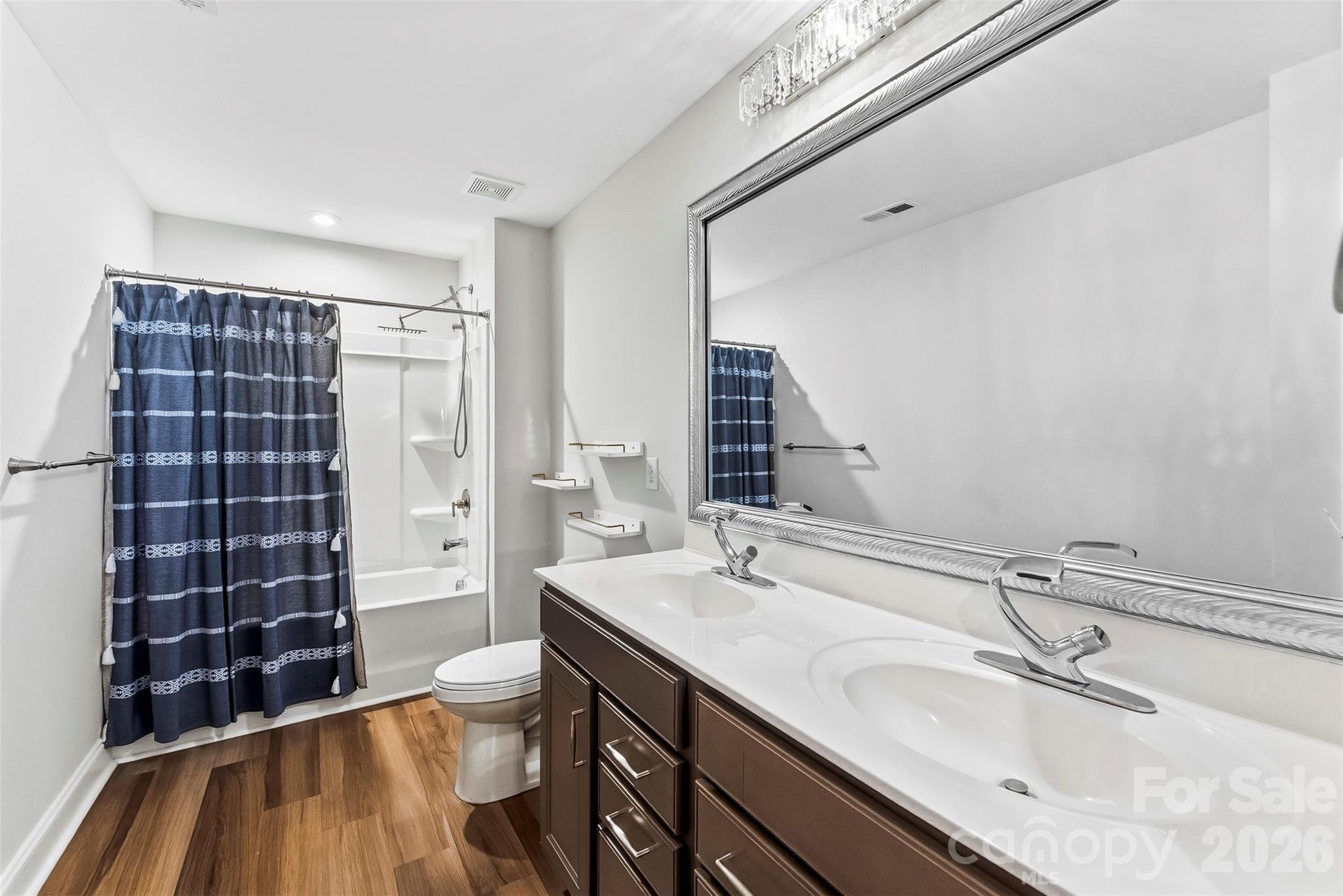Spacoius Secondary Full Bathroom has dual vanities, upgraded cabinetry and faucets/lighting. Rain Shower head - 1318 Poppy Way, Matthews
