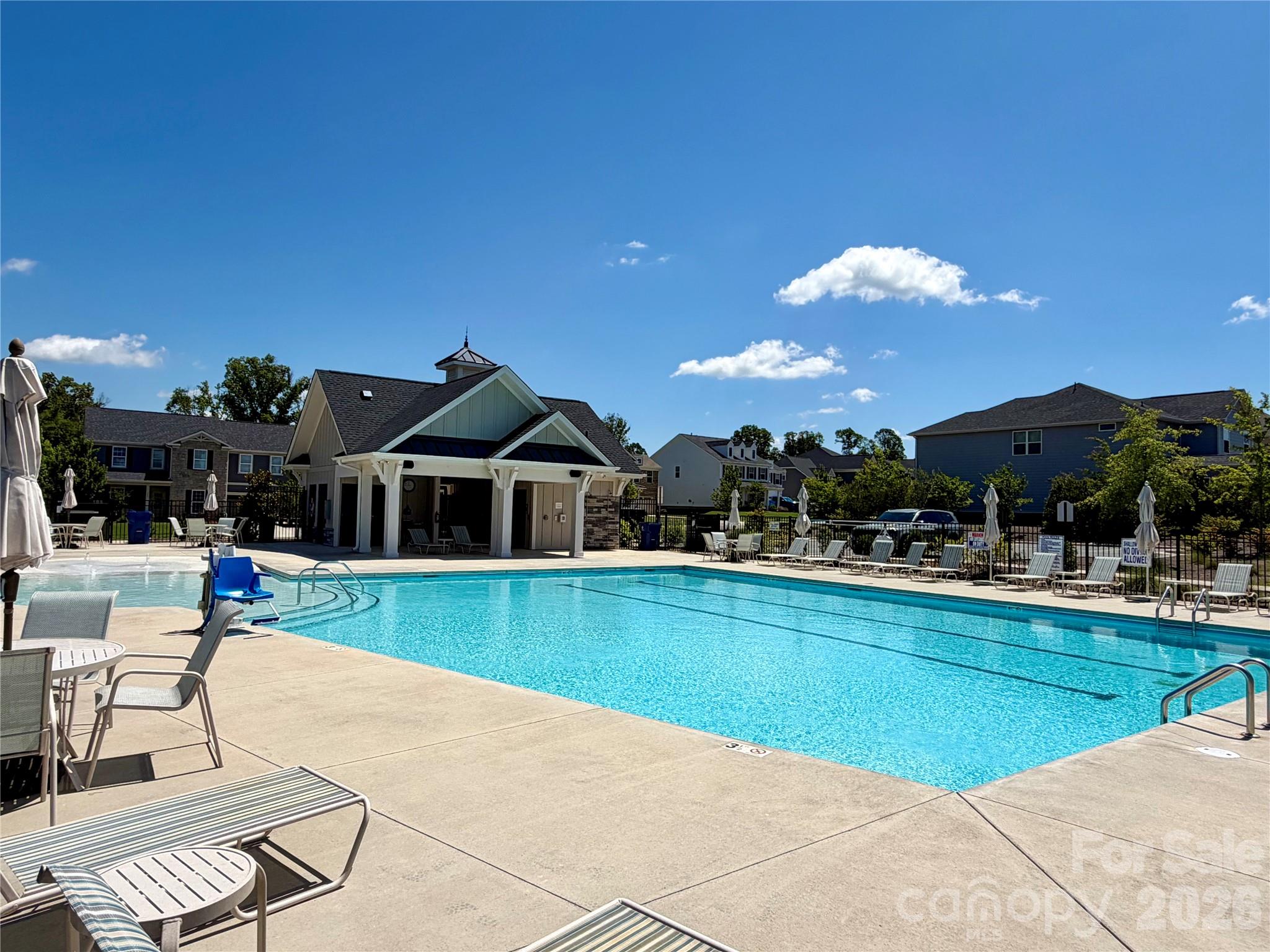 Spacious Community Pool with lots of chairs and umbrellas. Cabanna - 1318 Poppy Way, Matthews