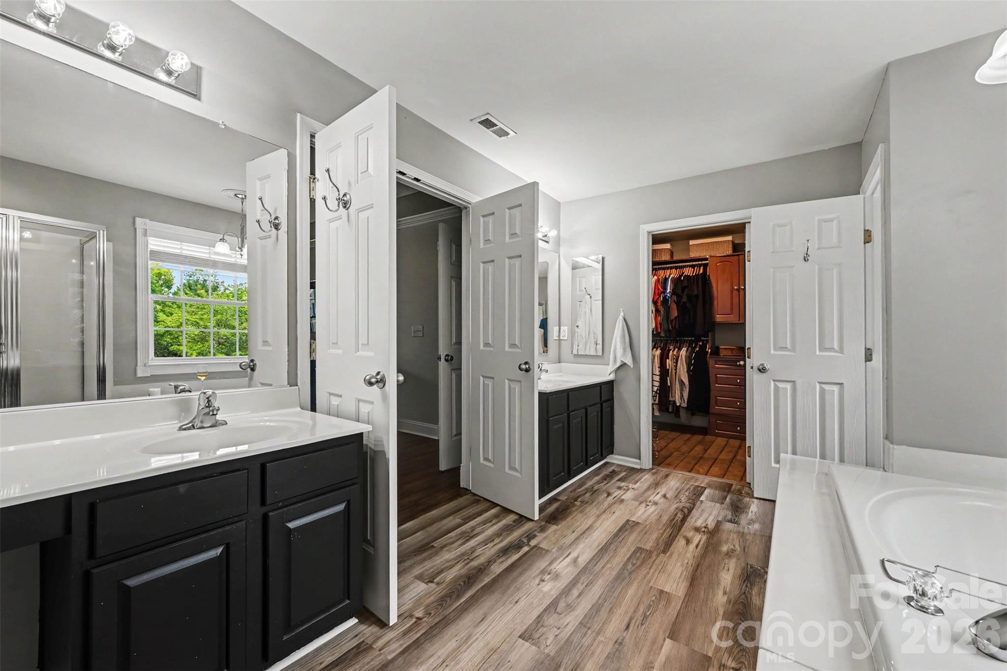 Upper primary bathroom with dual vanities. - 2442 Smith Cove Road, Denver