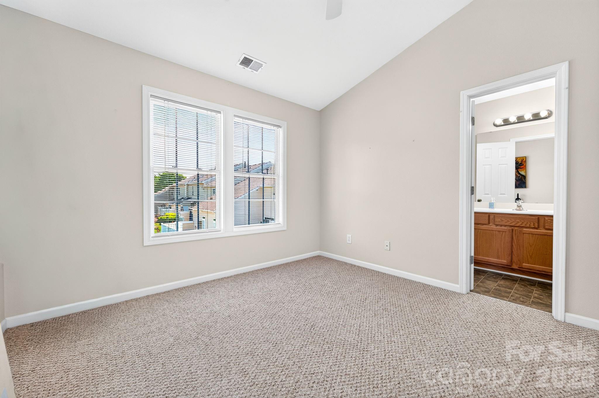 Second bedroom with vaulted ceiling and ceiling fan - 6312 Rhodins Lane, Indian Land
