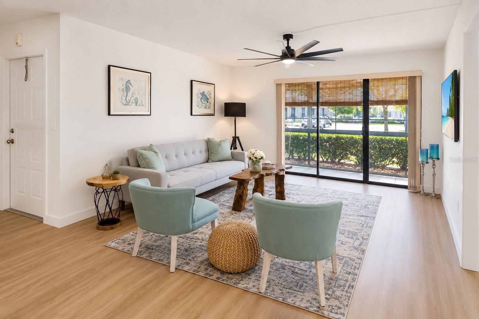 Living room w screen patio in background - 3211 LAKE PINE WAY E #A1, TARPON SPRINGS