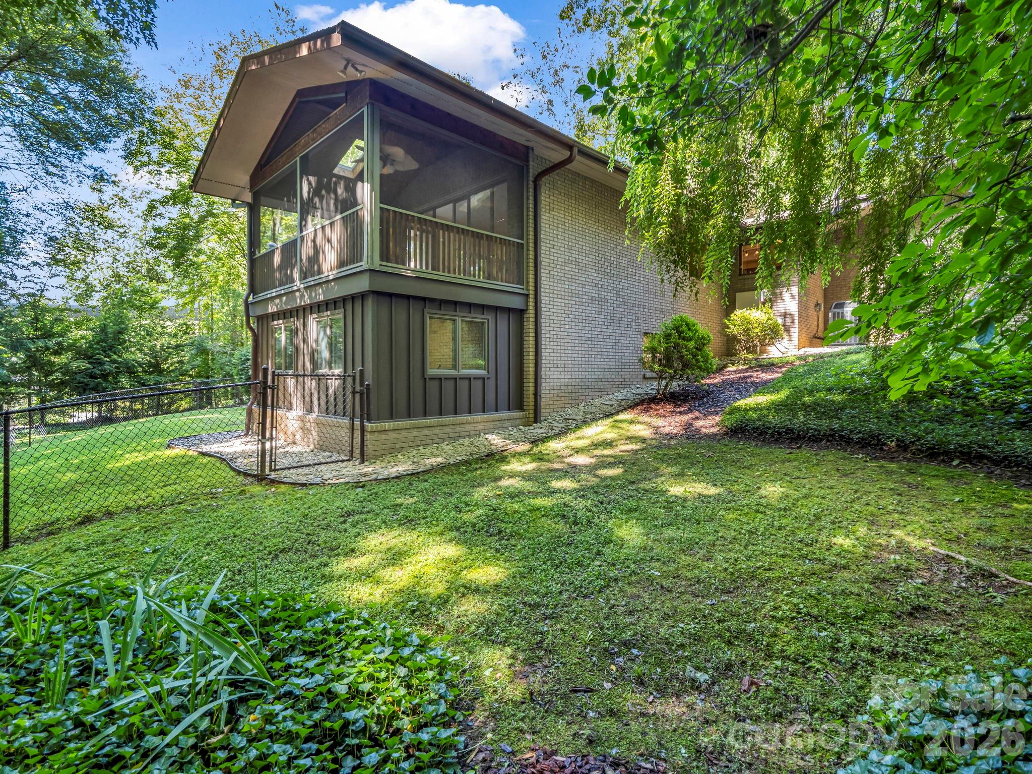 Rear of home with fenced backyard - 115 Woodhaven Drive, Hendersonville
