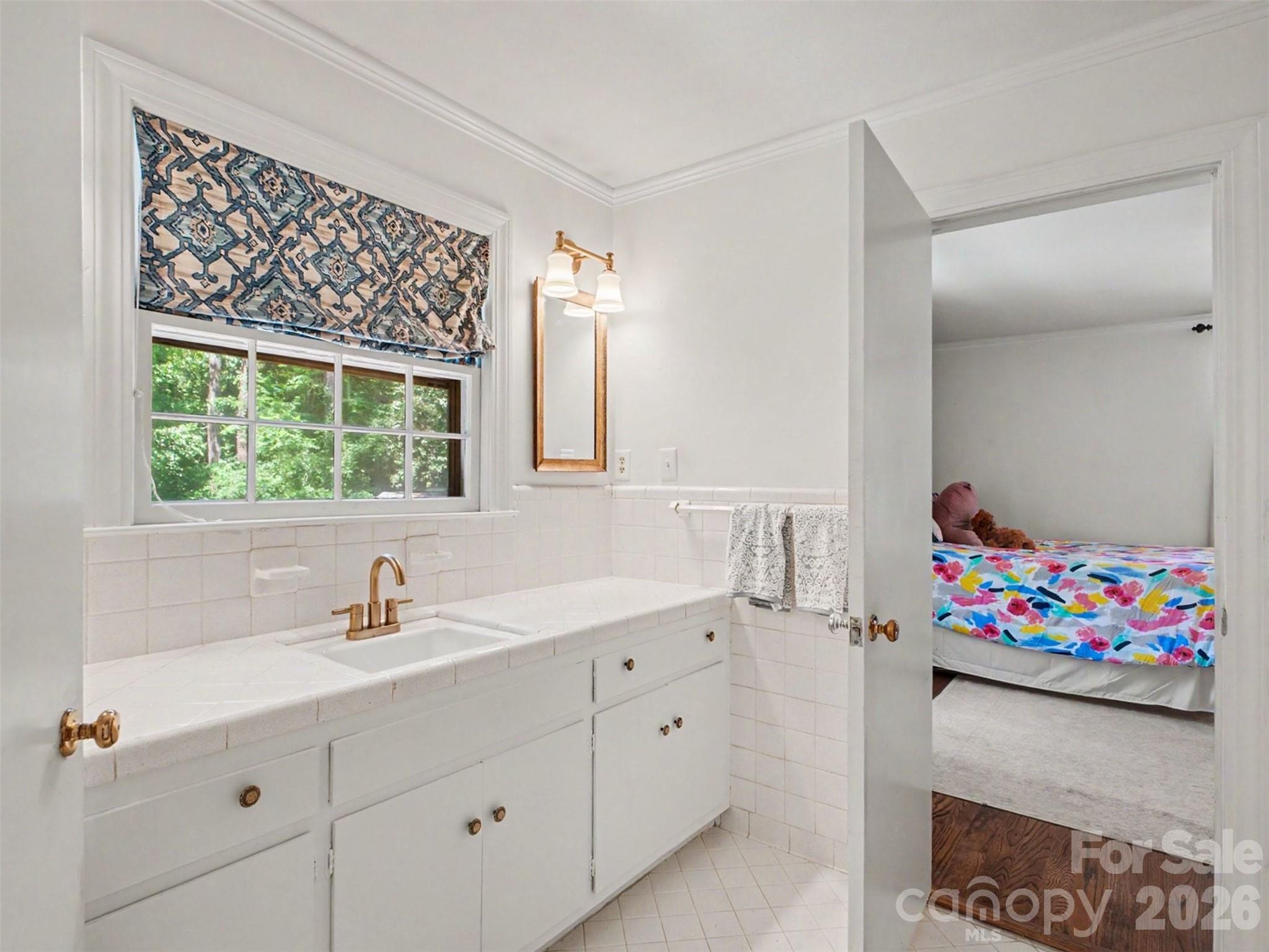 A well-appointed bath, shared with the bedroom next door but that could be closed off to provide an en suite for just the primary - 441 Claymont Street SE, Concord