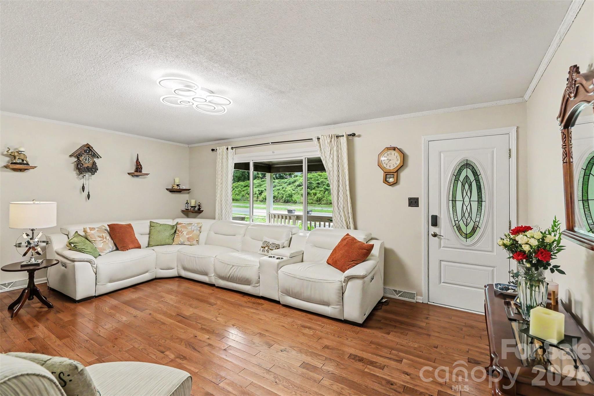 Hardwood floors, stained glass entry door, living room with room to breathe - 1306 Mooresville Road, Kannapolis