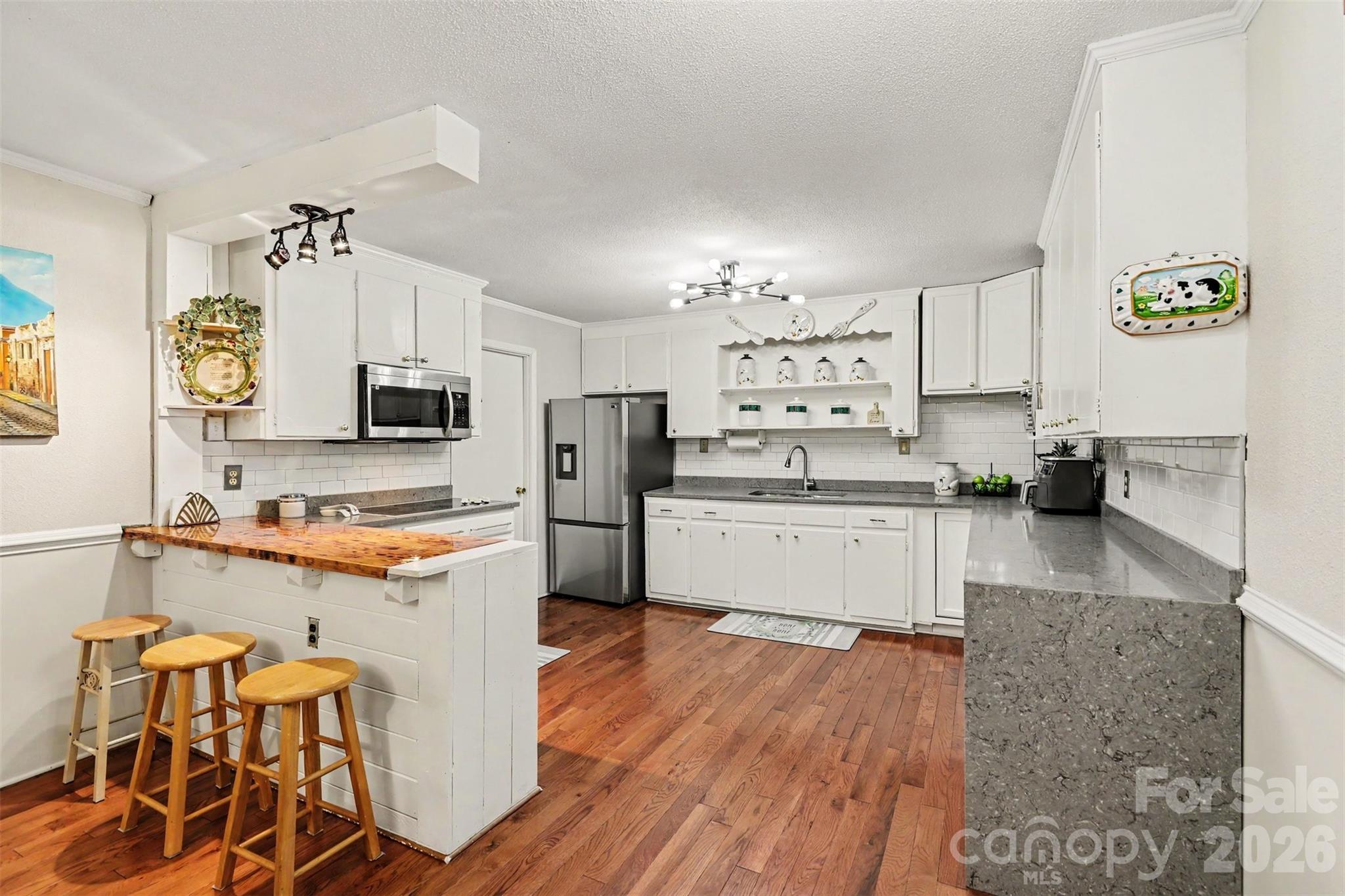 White cabinets, subway tile, stainless appliances, butcher block bar - 1306 Mooresville Road, Kannapolis