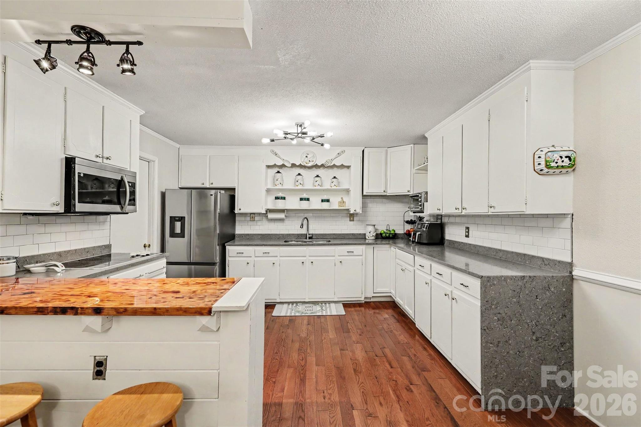 White cabinets, subway tile, stainless appliances, butcher block bar - 1306 Mooresville Road, Kannapolis