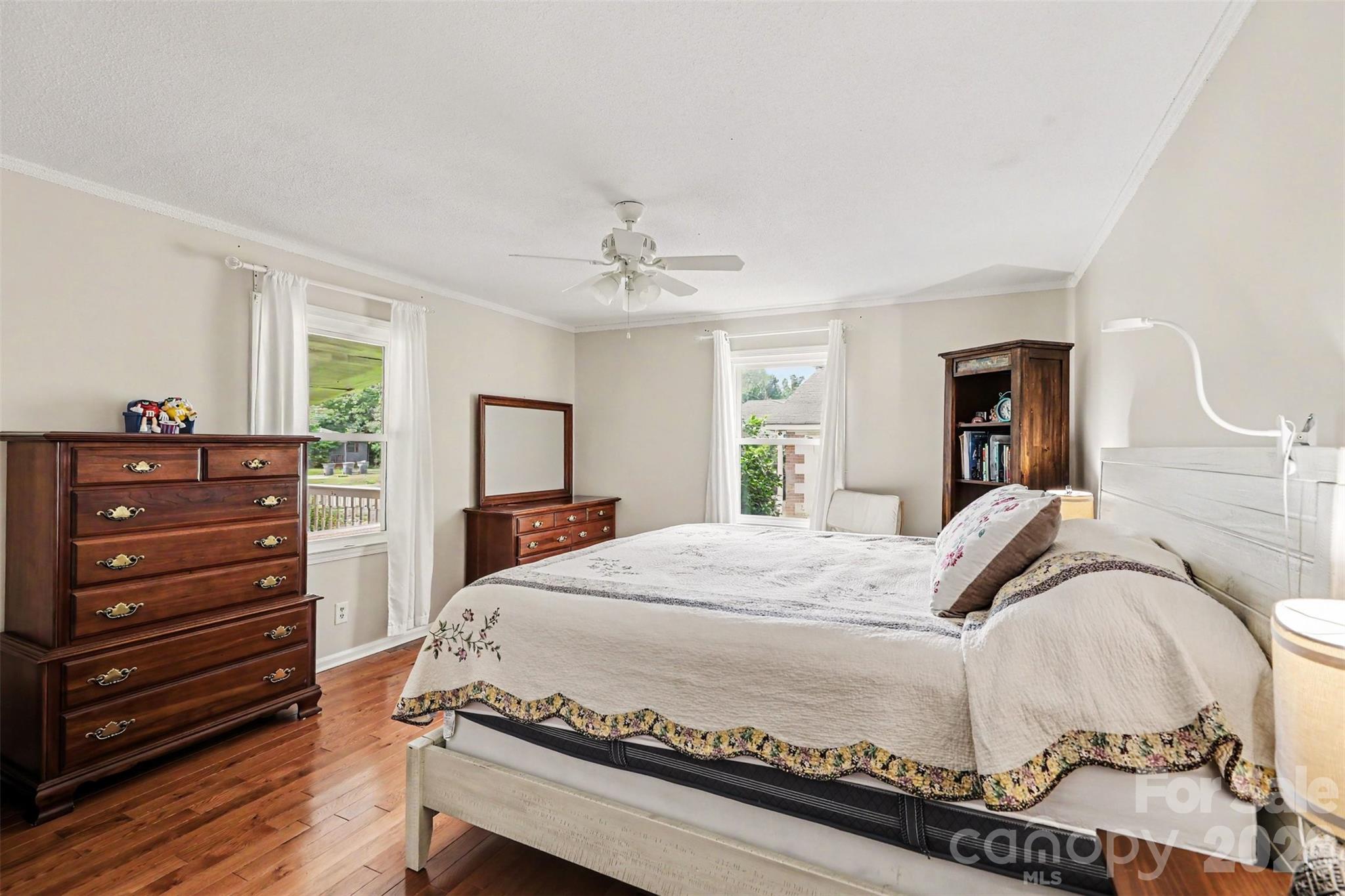 Primary bedroom, hardwood floors, dual windows, ceiling fan - 1306 Mooresville Road, Kannapolis