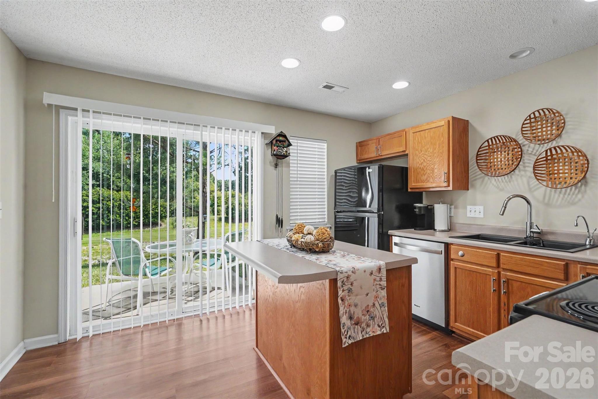 Island kitchen, opens up to backyard with green space - 605 Gelderland Drive, Matthews