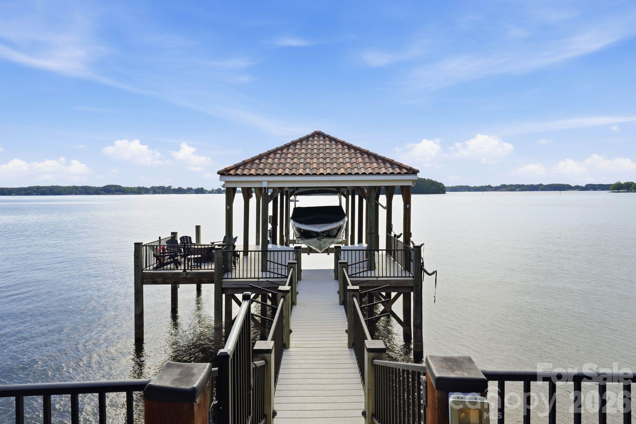 Covered dock with a tile roof, boatlift, & seating area. - 16920 Harbor Master Cove, Cornelius
