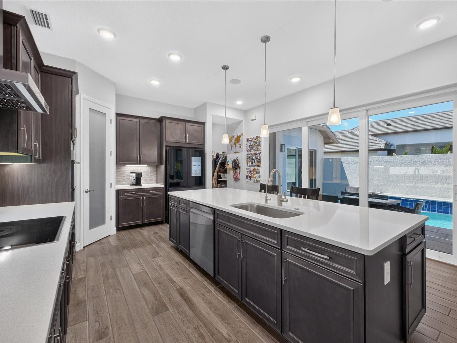 Dining and kitchen open to pool area - 196 HAMPTON LOOP, DAVENPORT