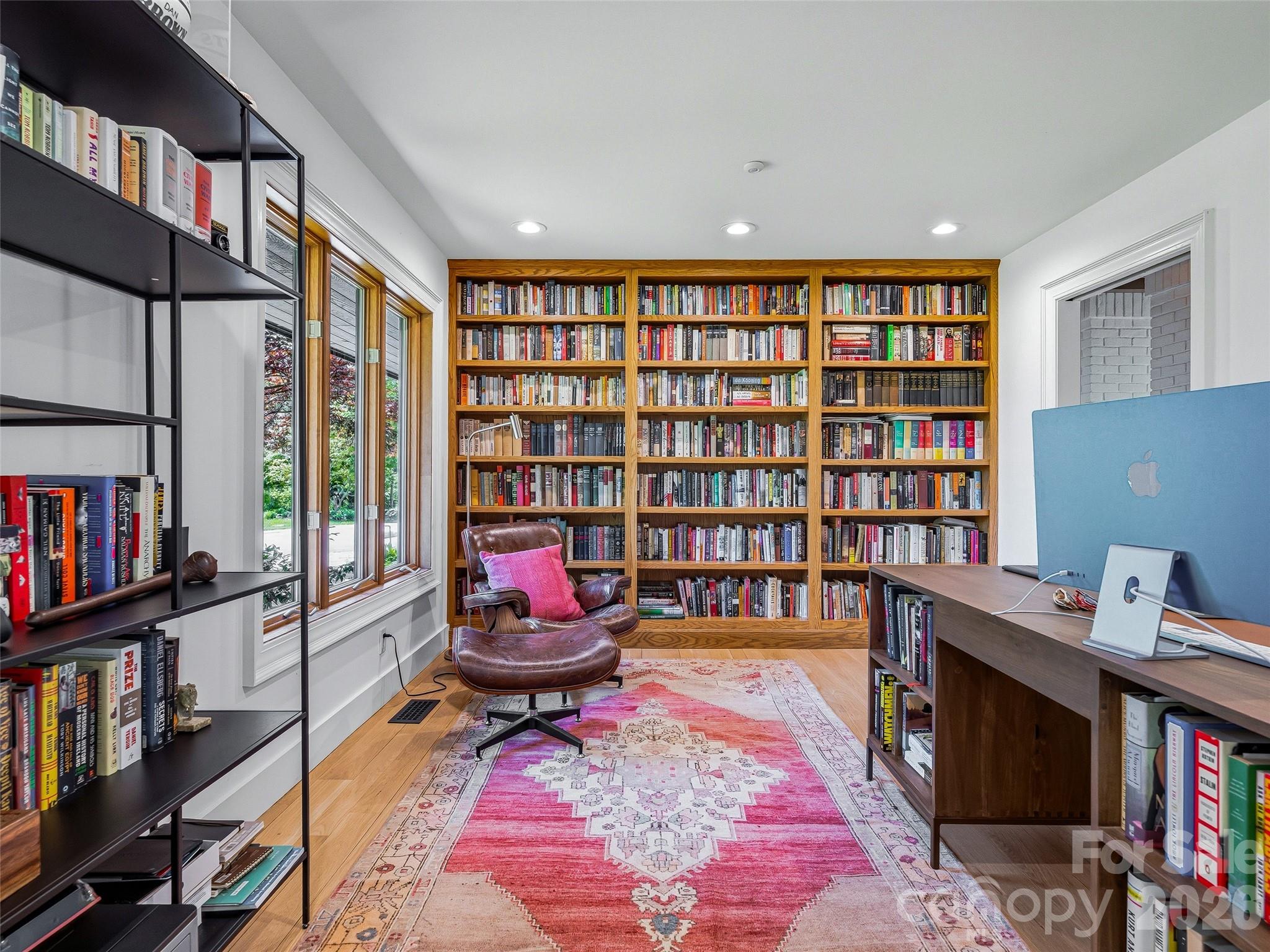 The office features a built in wall of custom Oak bookcases. - 100 Big Spring Drive, Asheville