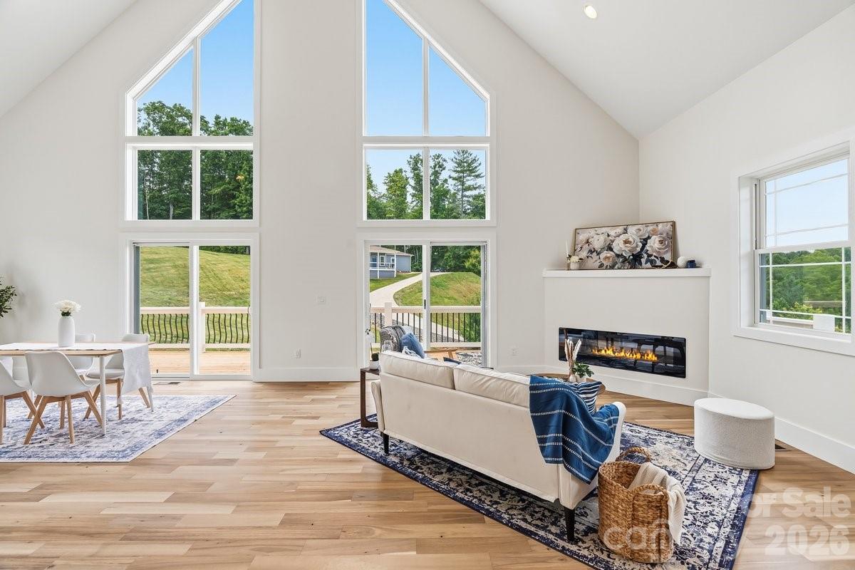 Big windows for natural light in open living area - 49 Grace Court, Mars Hill