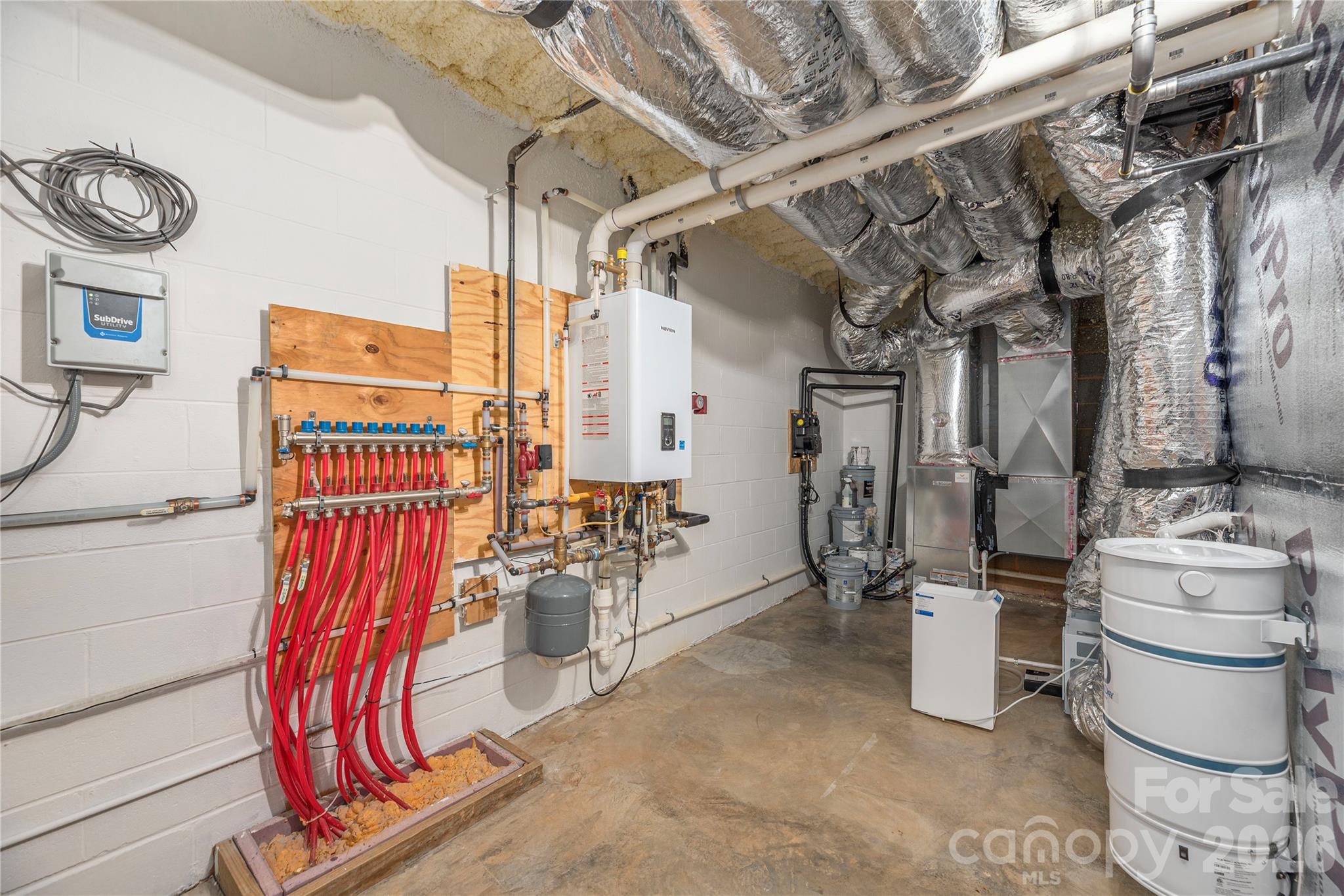 Immaculate and accessible utility room with geothermal heating and cooling, tankless water heater, and air filtration - 28 Garren View Drive, Fairview