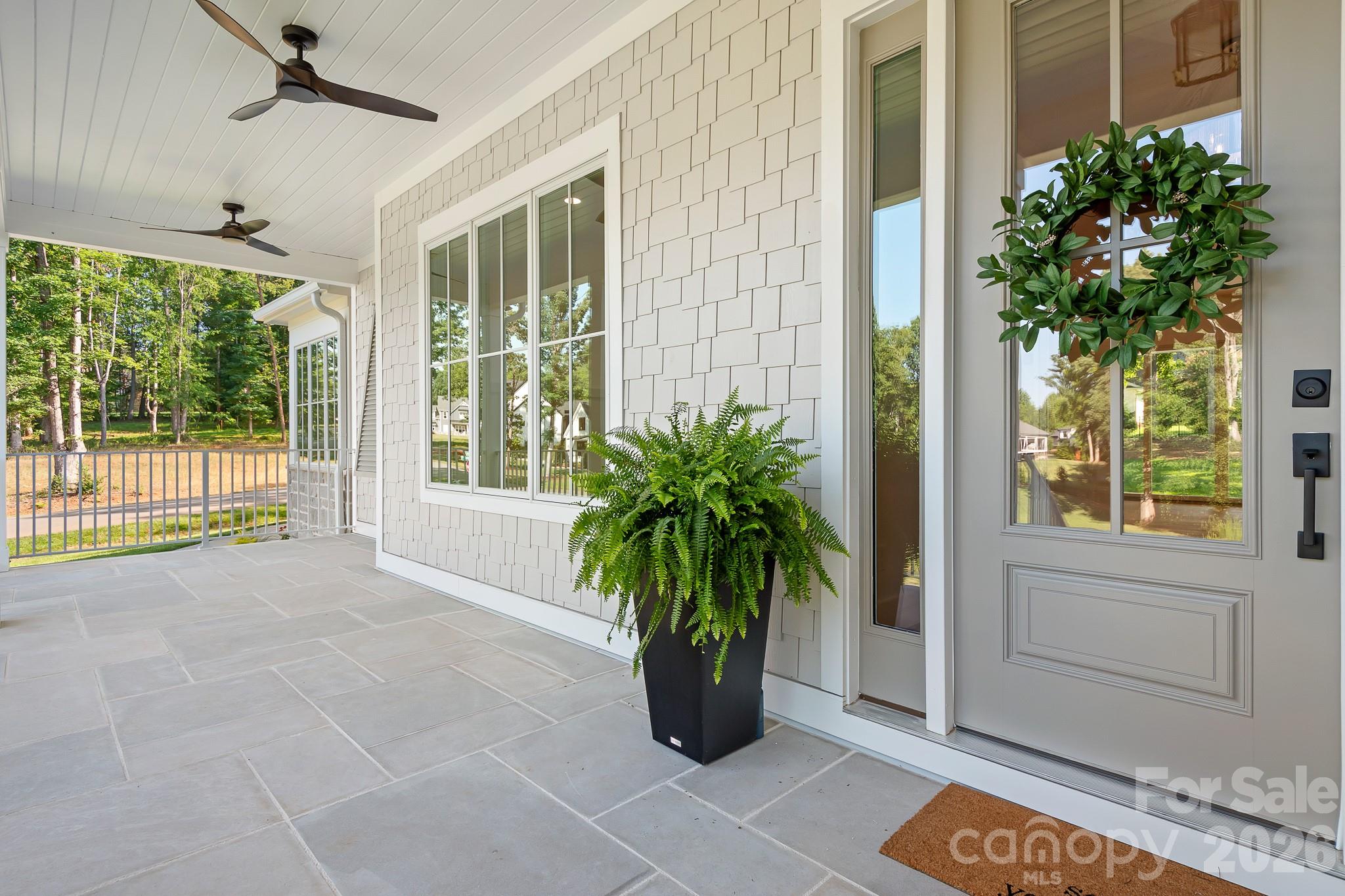 Great Limestone front porch with fans and room for a sofa swing - 126 Manorly Lane, Mooresville