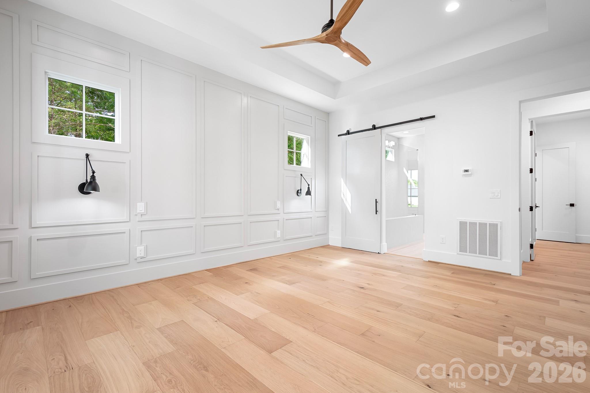 Sliding barn door to Primary ensuite bath - 126 Manorly Lane, Mooresville