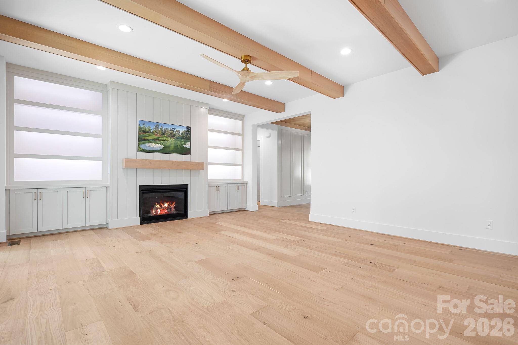 Family Room with lit Built-ins and beam ceiling - 126 Manorly Lane, Mooresville