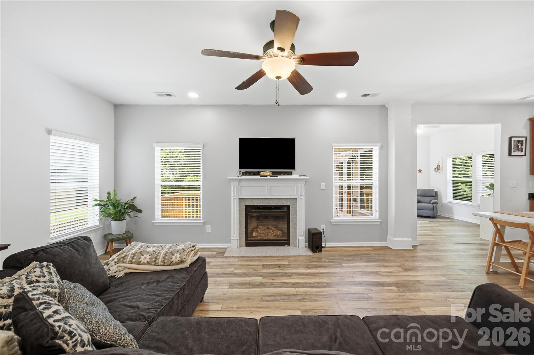 Cozy up by the gas-log fireplace in the light-filled great room - 1034 Canopy Drive, Indian Trail