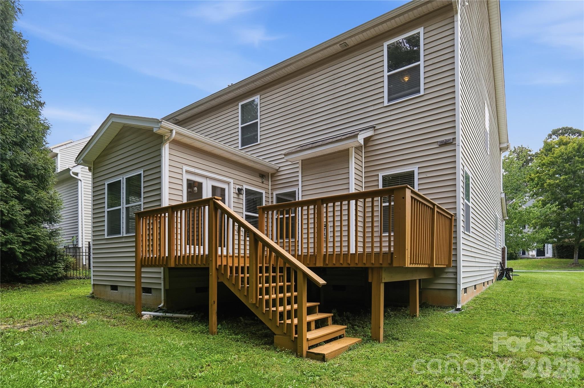 Rear exterior with a spacious deck overlooking the yard - 1034 Canopy Drive, Indian Trail