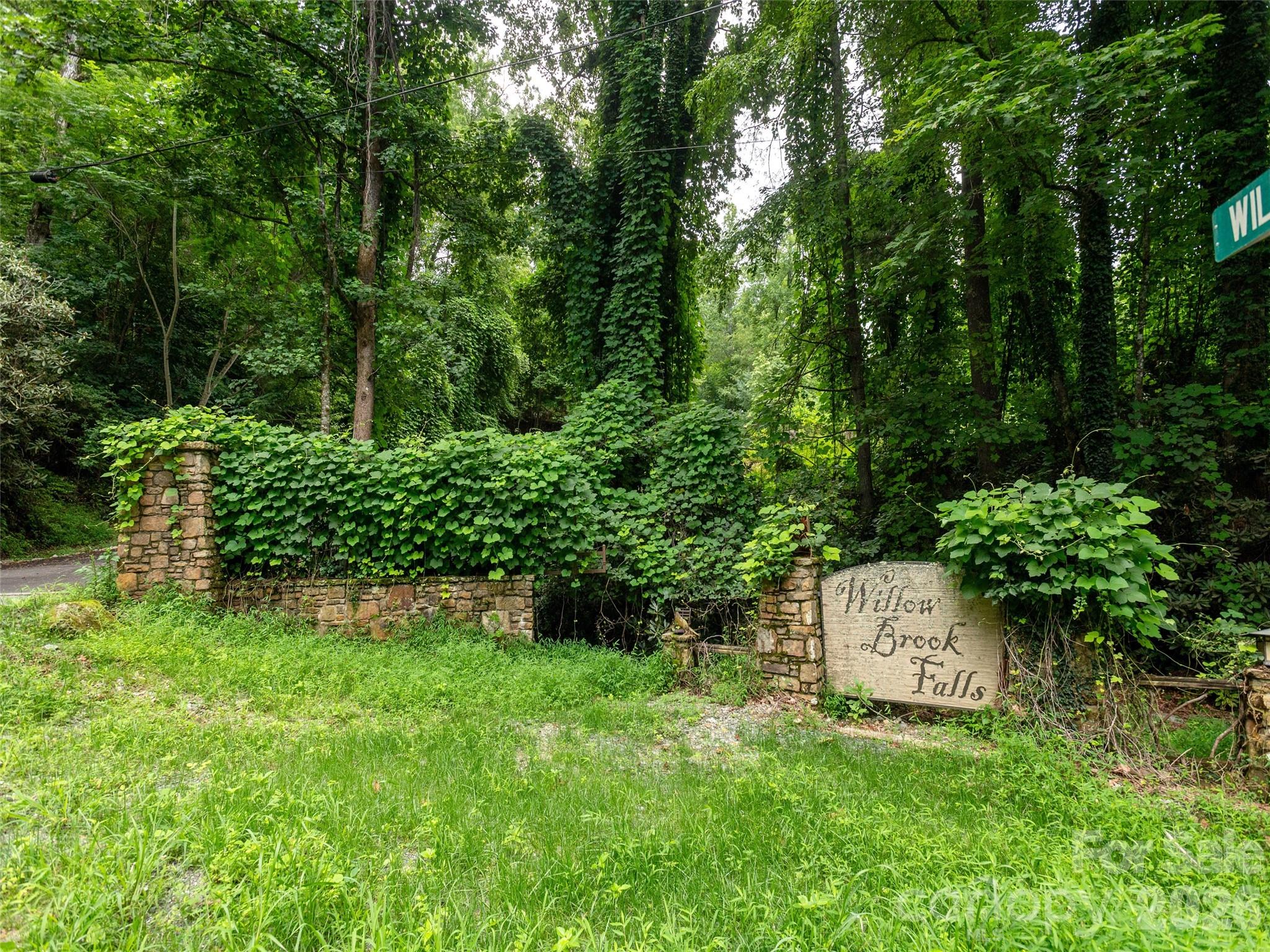 Entry signage from Willow Road provides a welcoming and clearly defined entrance to the community. - 0 Willow Falls Lane, Hendersonville