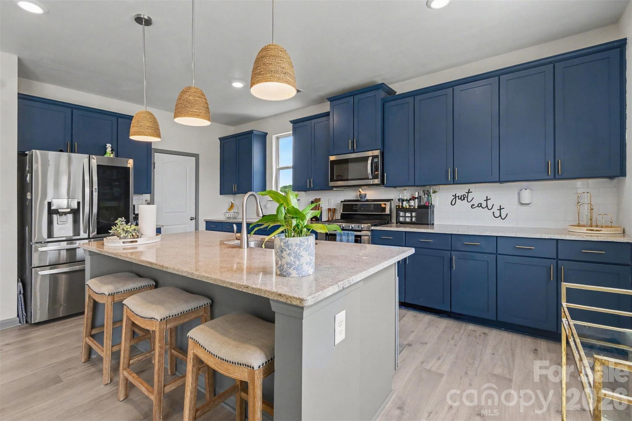 Enjoy meals from this fantastic Chef's Kitchen with quartz countertops, backsplash, a large island and MORE! - 2055 Yearden Lane, Monroe