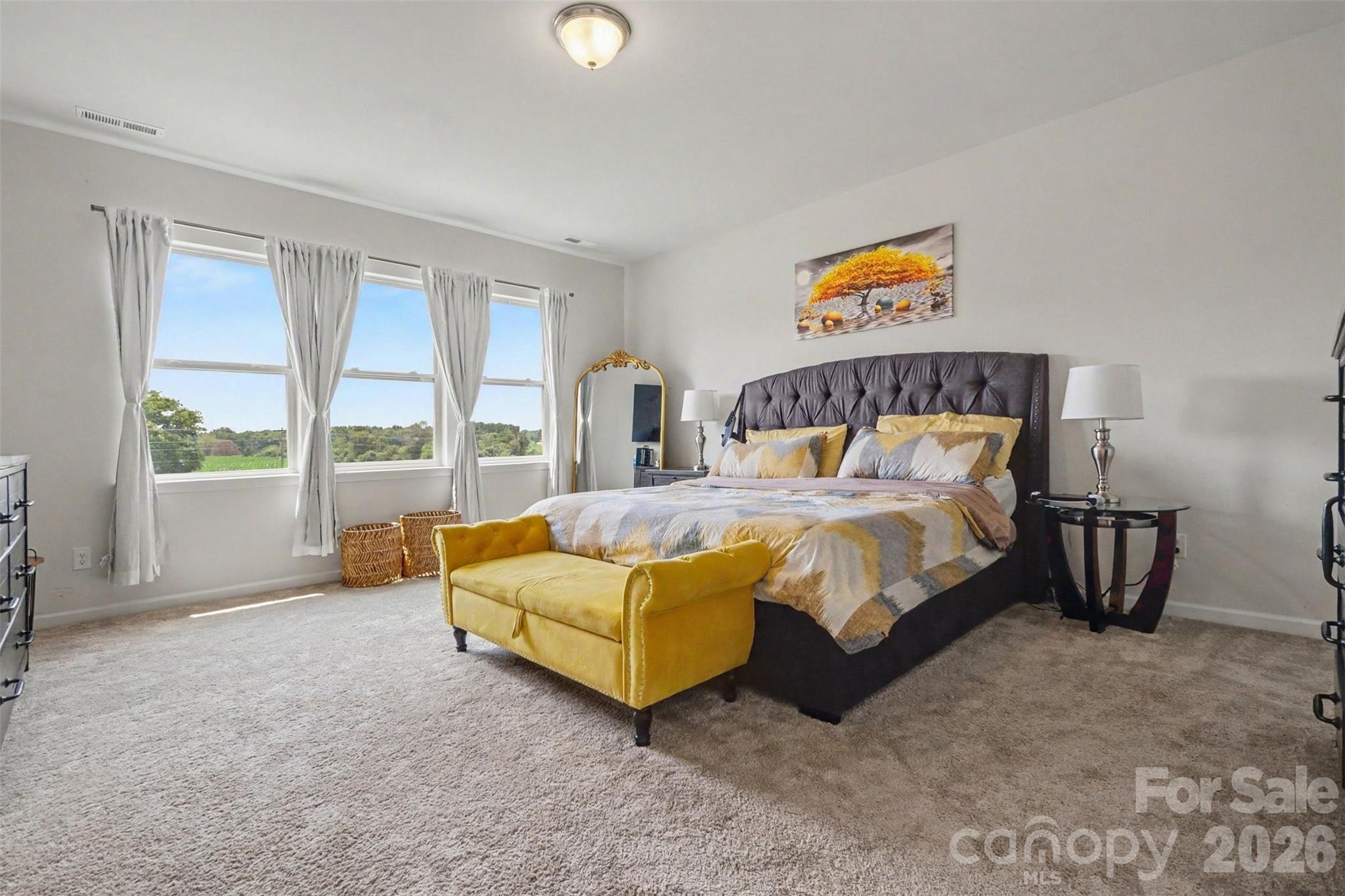 The primary bedroom features lots of windows - lots of natural light! - 2055 Yearden Lane, Monroe