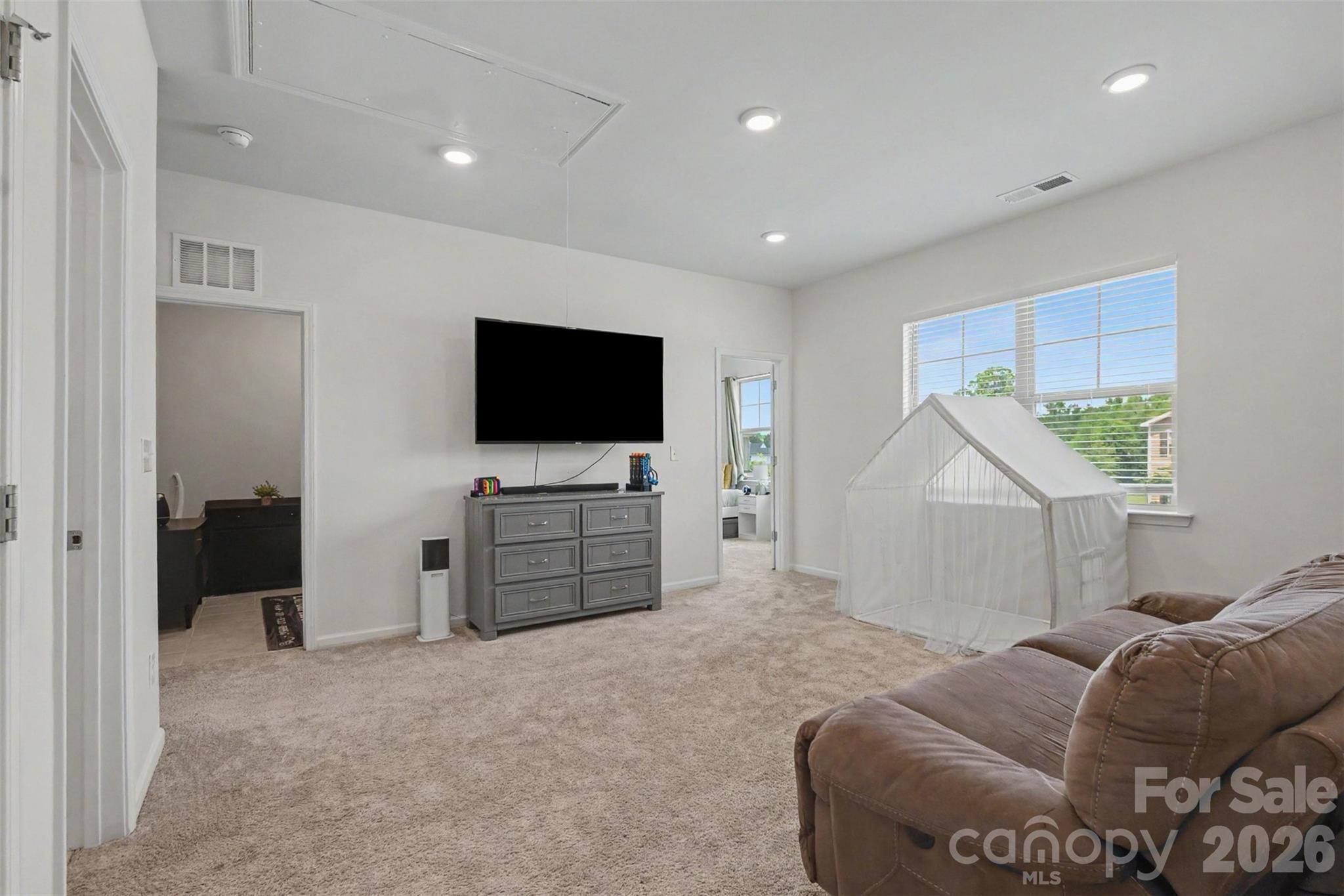The upstairs flex space/loft is a wonderful place for the bedrooms to come together for entertainment. It is freshly painted and is adorned with both recessed lighting and natural light! - 2055 Yearden Lane, Monroe