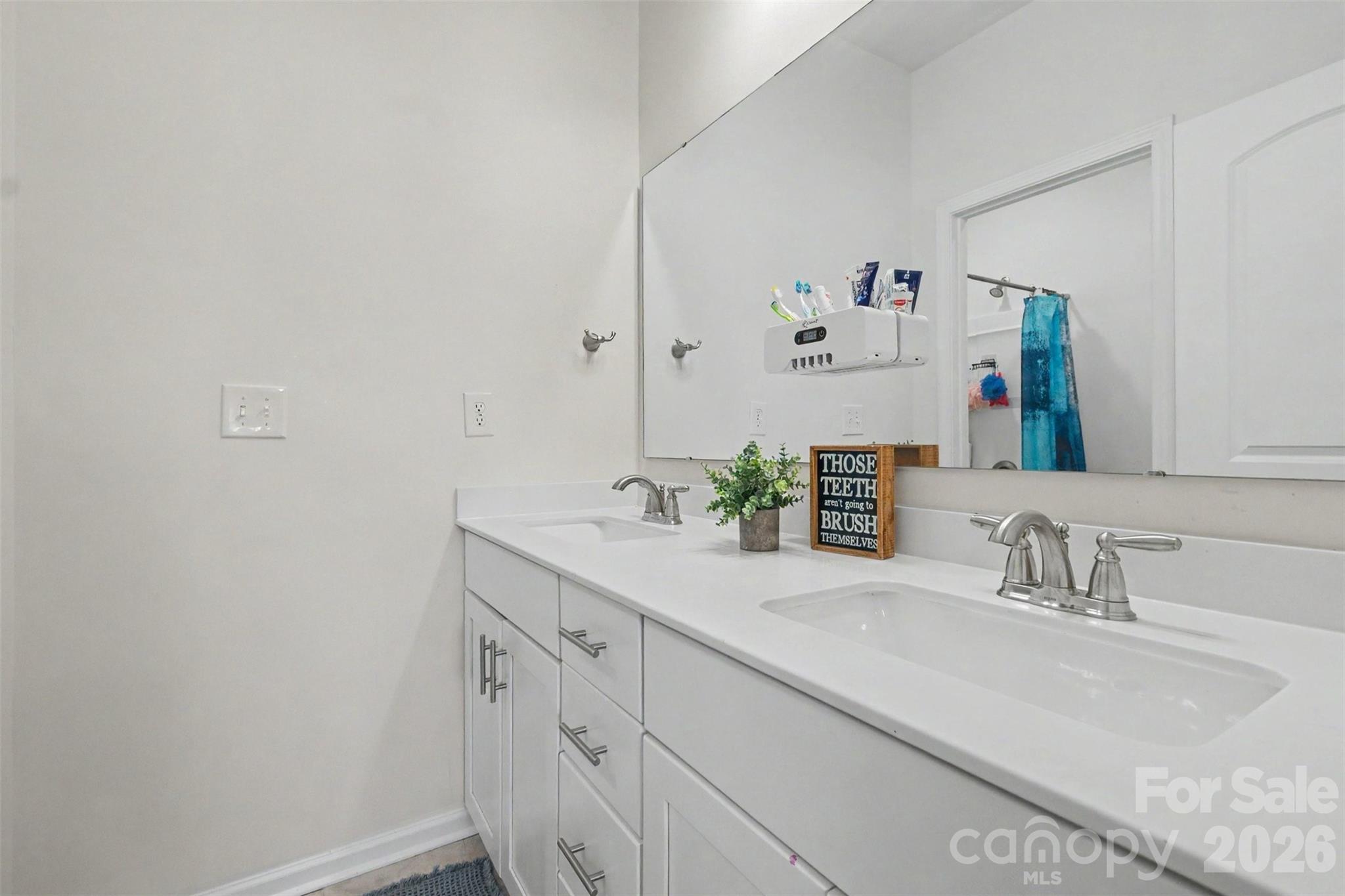 Featuring a separate area for bathing, the second bathroom features a solid dual vanity with lots of drawers and cabinets. - 2055 Yearden Lane, Monroe