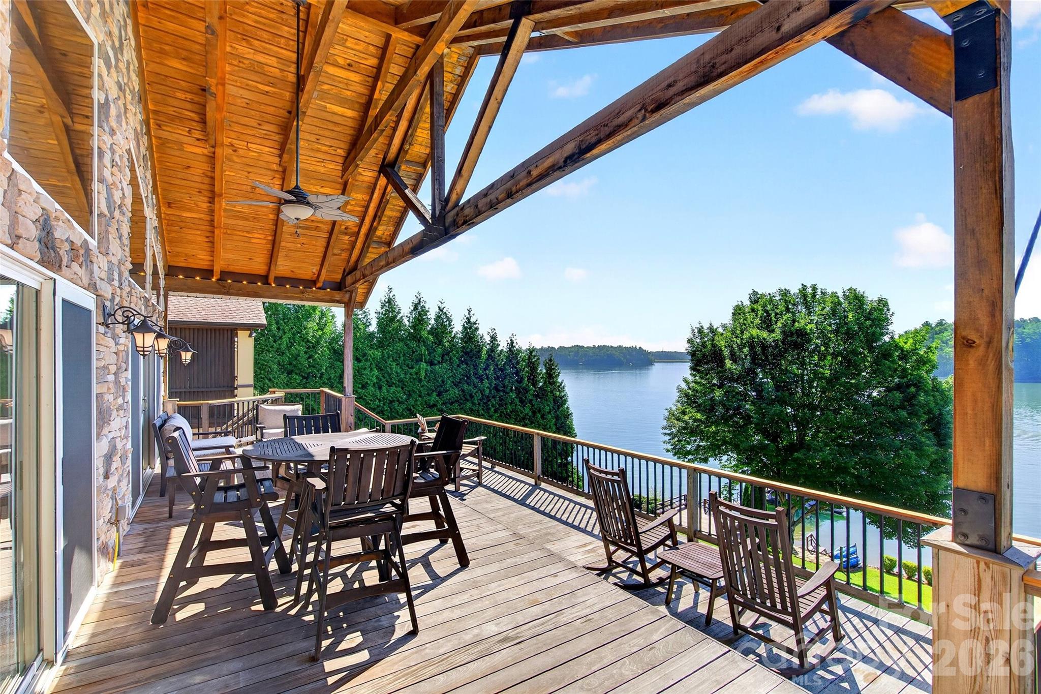 Weather-resistant IPE deck arranged for outdoor dining and lounging above the Lake James shoreline. - 831 Lake Club Drive, Nebo
