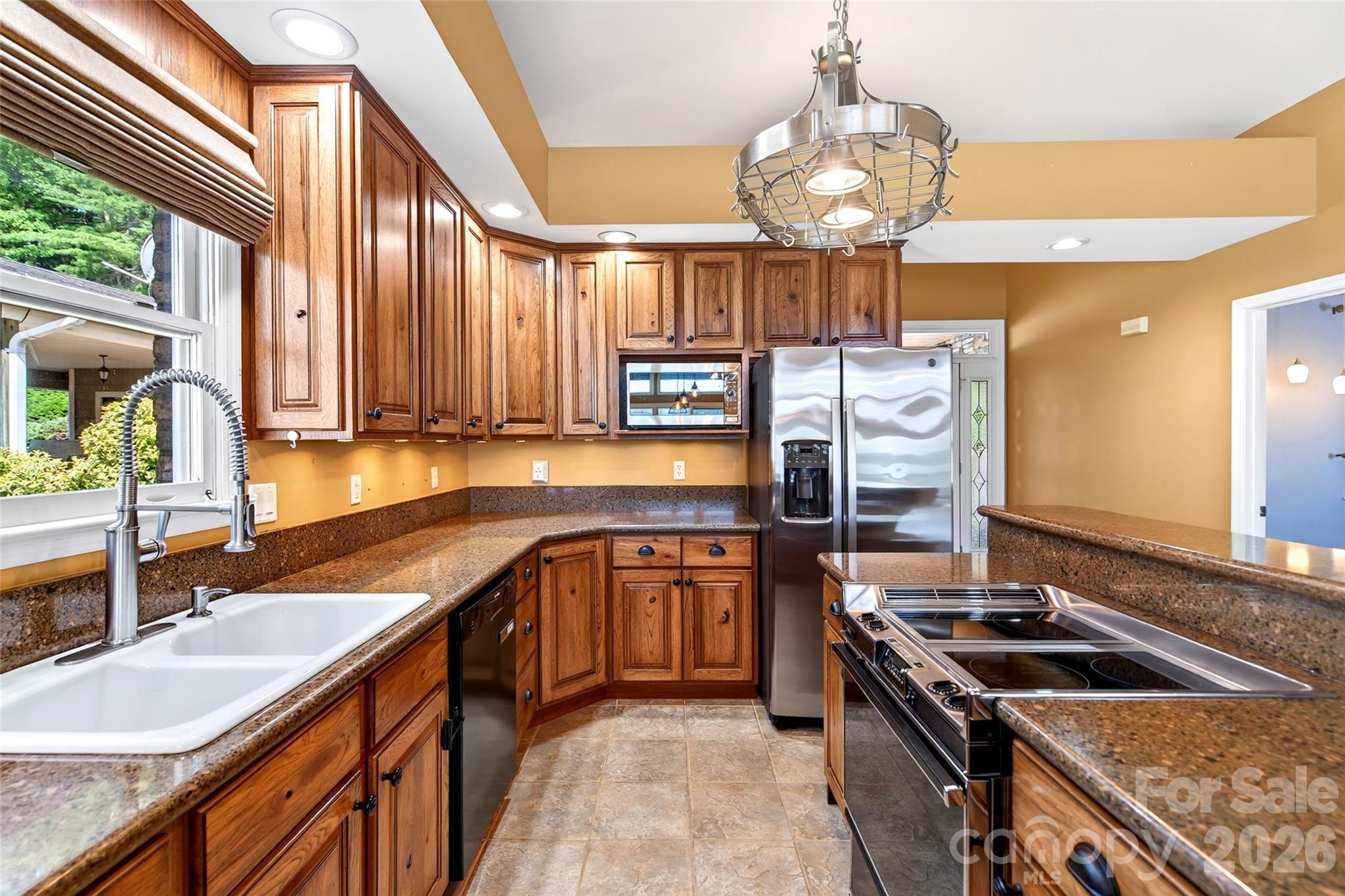 Kitchen with stainless appliances, quartz counters, and full custom hickory cabinetry. - 831 Lake Club Drive, Nebo