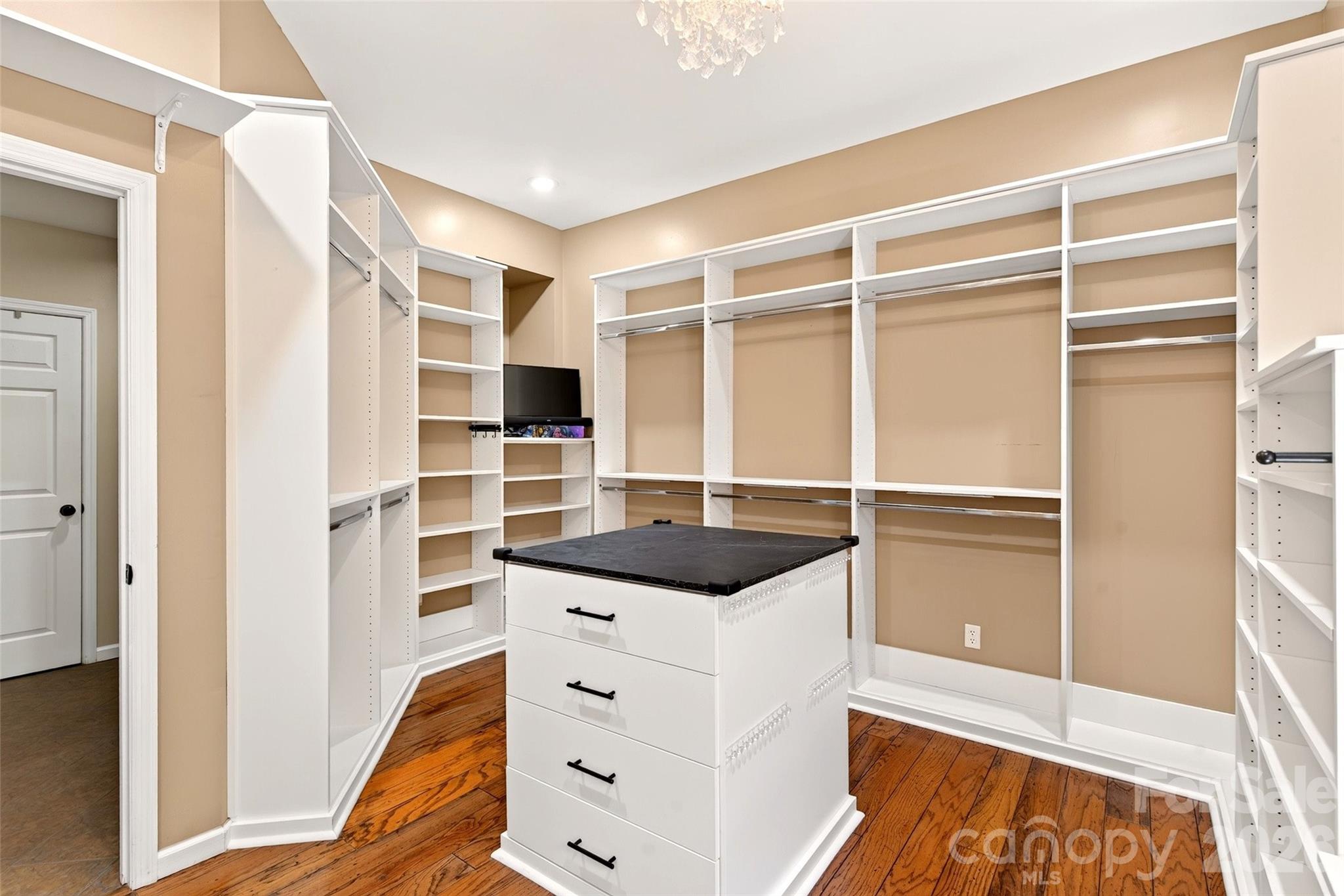 Primary suite closet with built-in shelving and drawer storage adjoining the primary suite. - 831 Lake Club Drive, Nebo