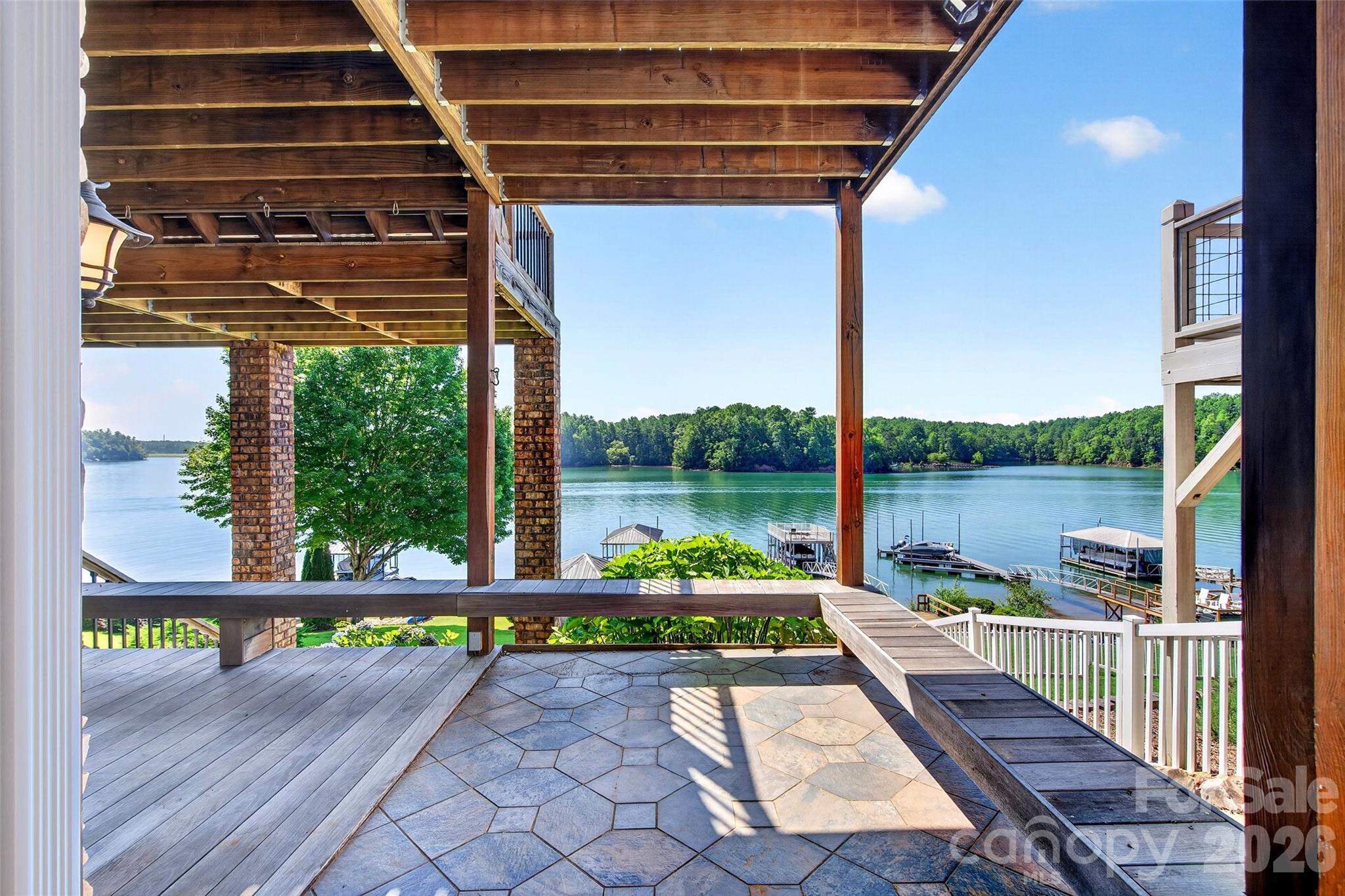 Lake-side elevation of 831 Lake Club Drive showing stacked IPE decks and covered porches facing the water. - 831 Lake Club Drive, Nebo