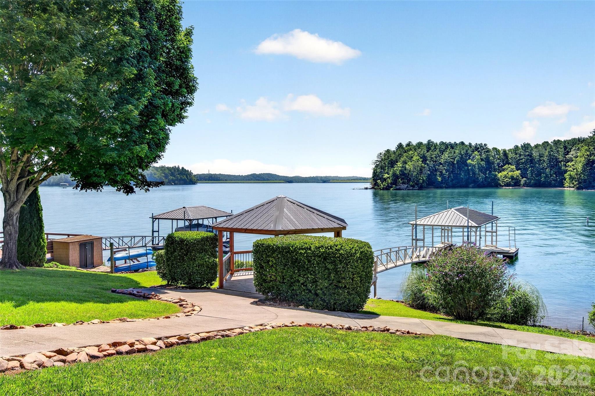 Level cleared lawn running from the house past the gazebo to the private dock on Lake James. - 831 Lake Club Drive, Nebo
