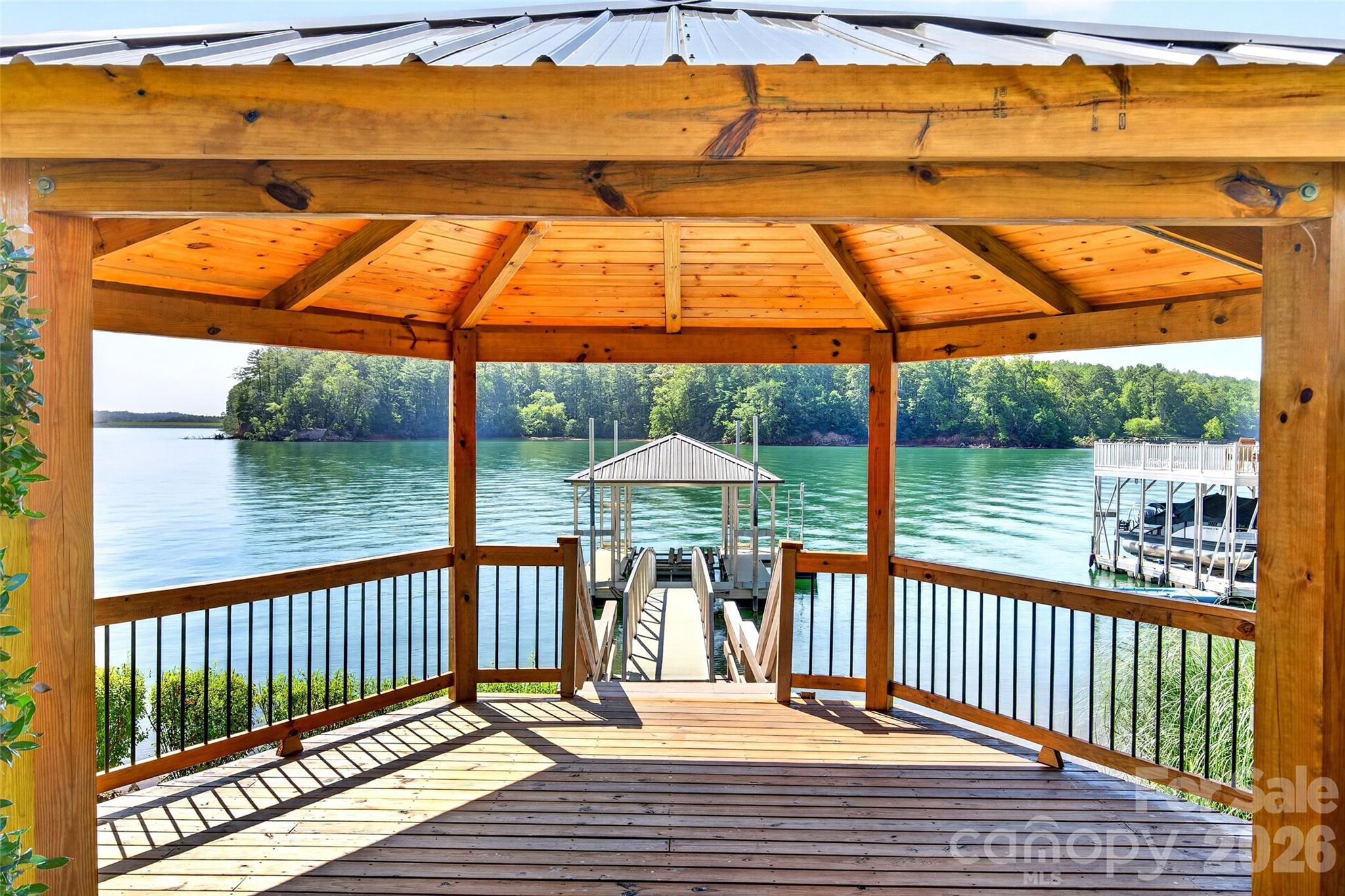 Finished gazebo with electricity positioned between the lawn and the private dock. - 831 Lake Club Drive, Nebo